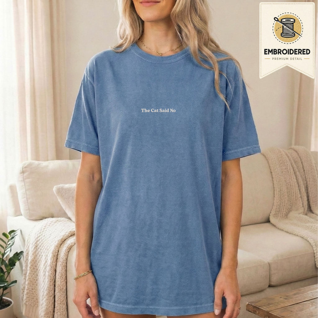 Woman wearing a blue jean embroidered The Cat Said No cat t-shirt