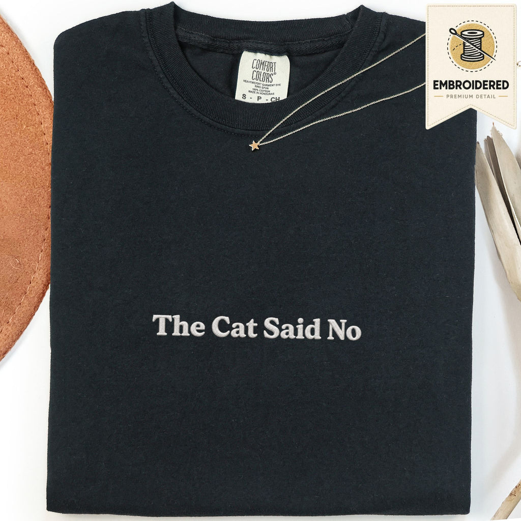 Black embroidered cat t-shirt with a small The Cat Said No chest design, shown flat