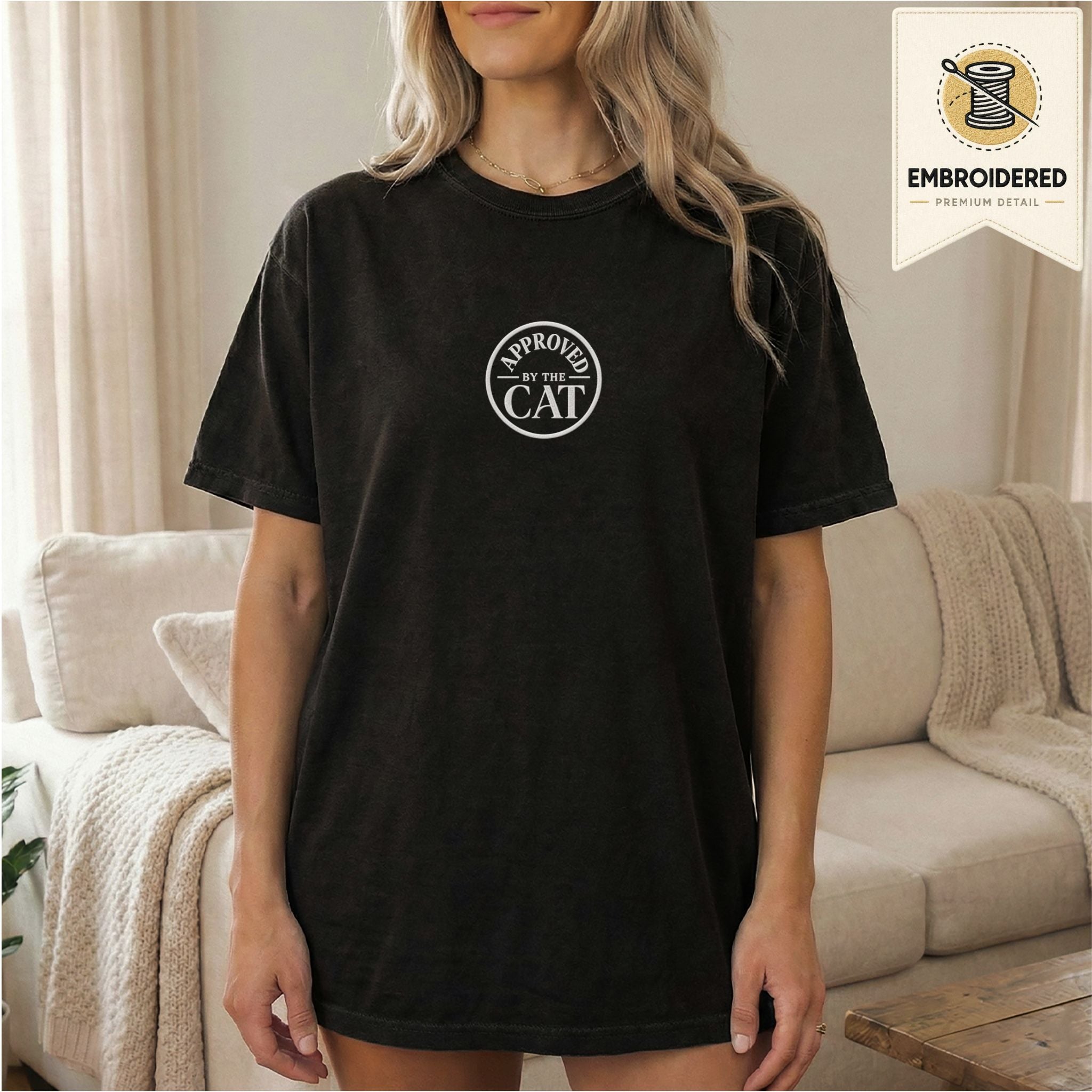 Woman wearing a black embroidered Approved by the Cat cat t-shirt