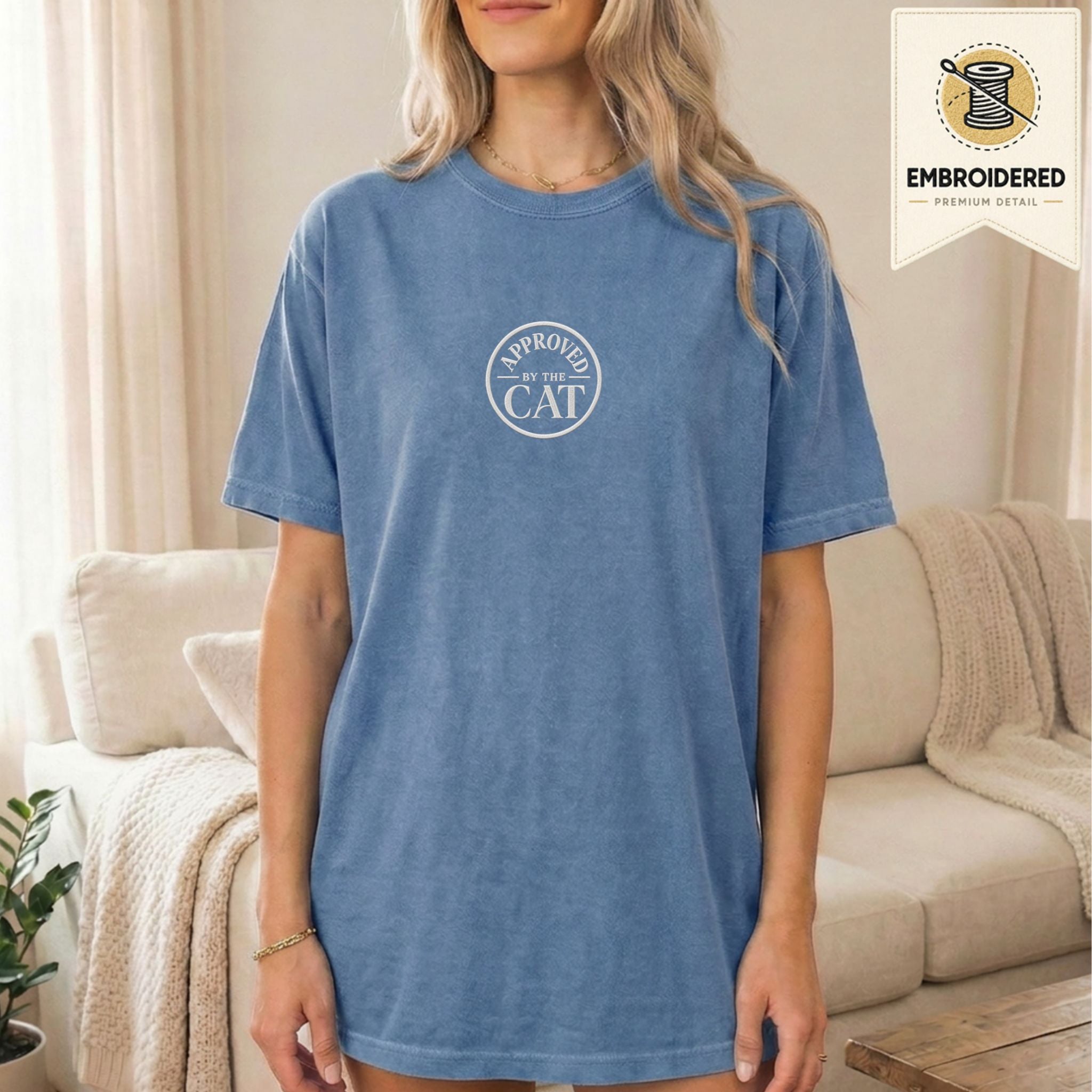 Woman wearing a blue jean embroidered Approved by the Cat cat t-shirt