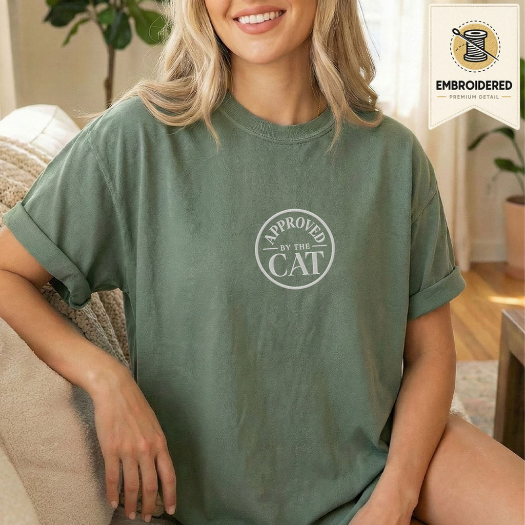 Woman wearing a moss green embroidered Approved by the Cat cat t-shirt