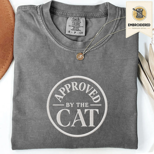 Pepper embroidered cat t-shirt with a small Approved by the Cat seal chest design, shown flat