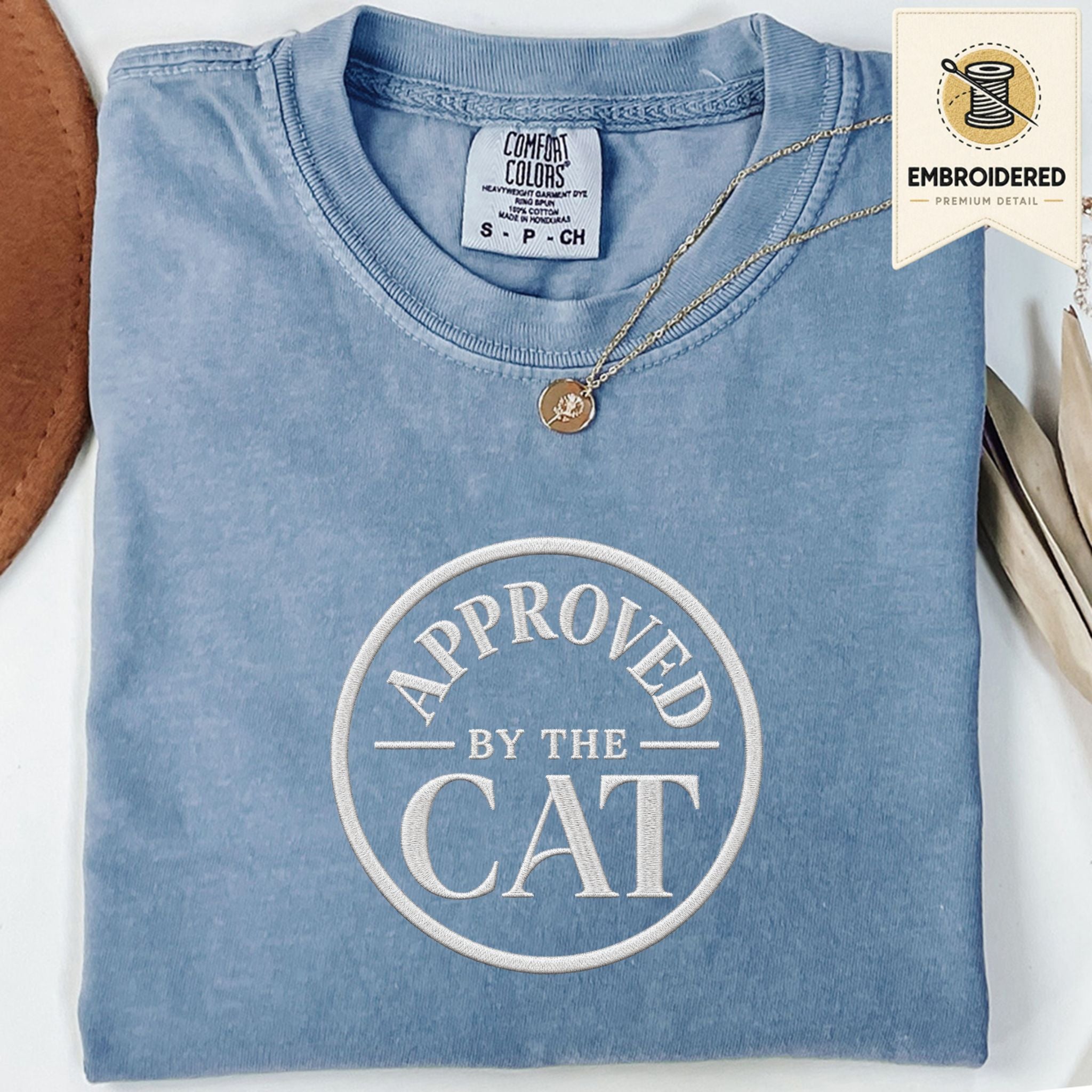 Blue Jean embroidered cat t-shirt with a small Approved by the Cat seal chest design, shown flat