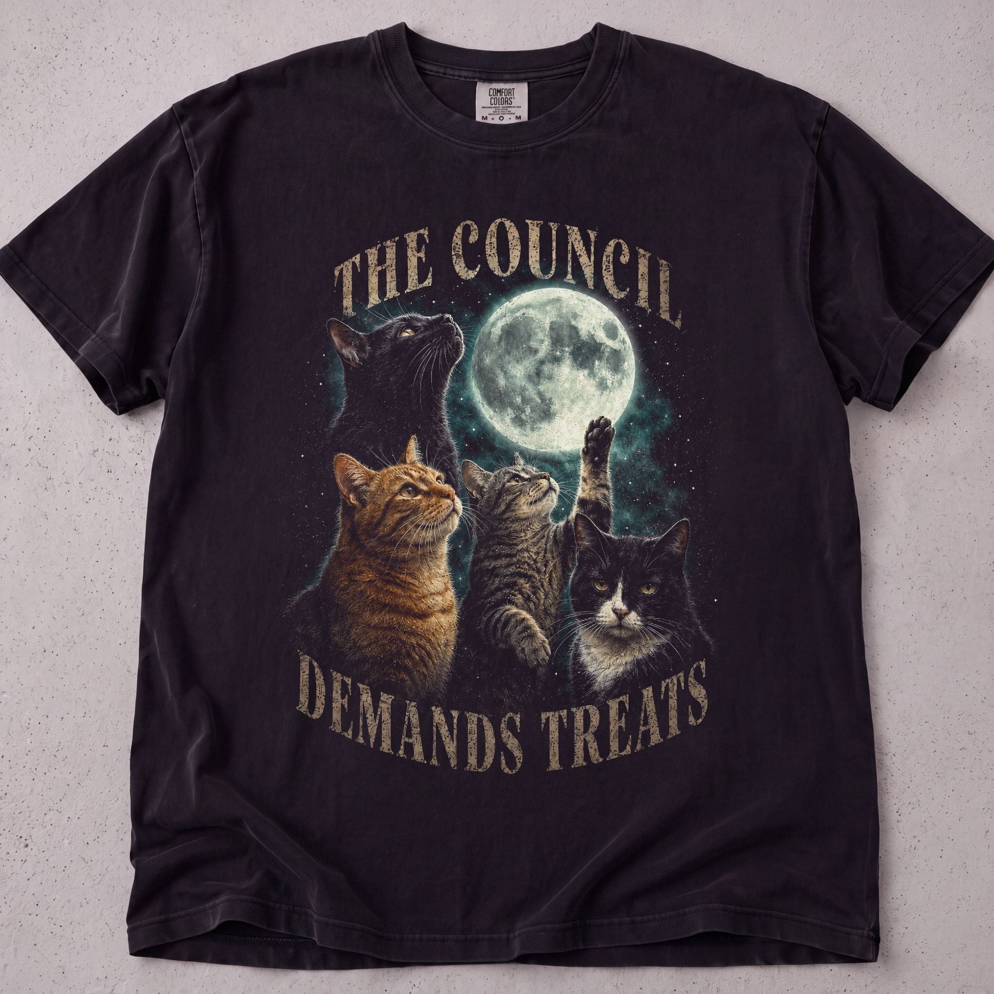 Black cat t-shirt with The Council Demands Treats printed graphic, funny cat lover tee on soft Comfort Colors cotton, flat lay front view