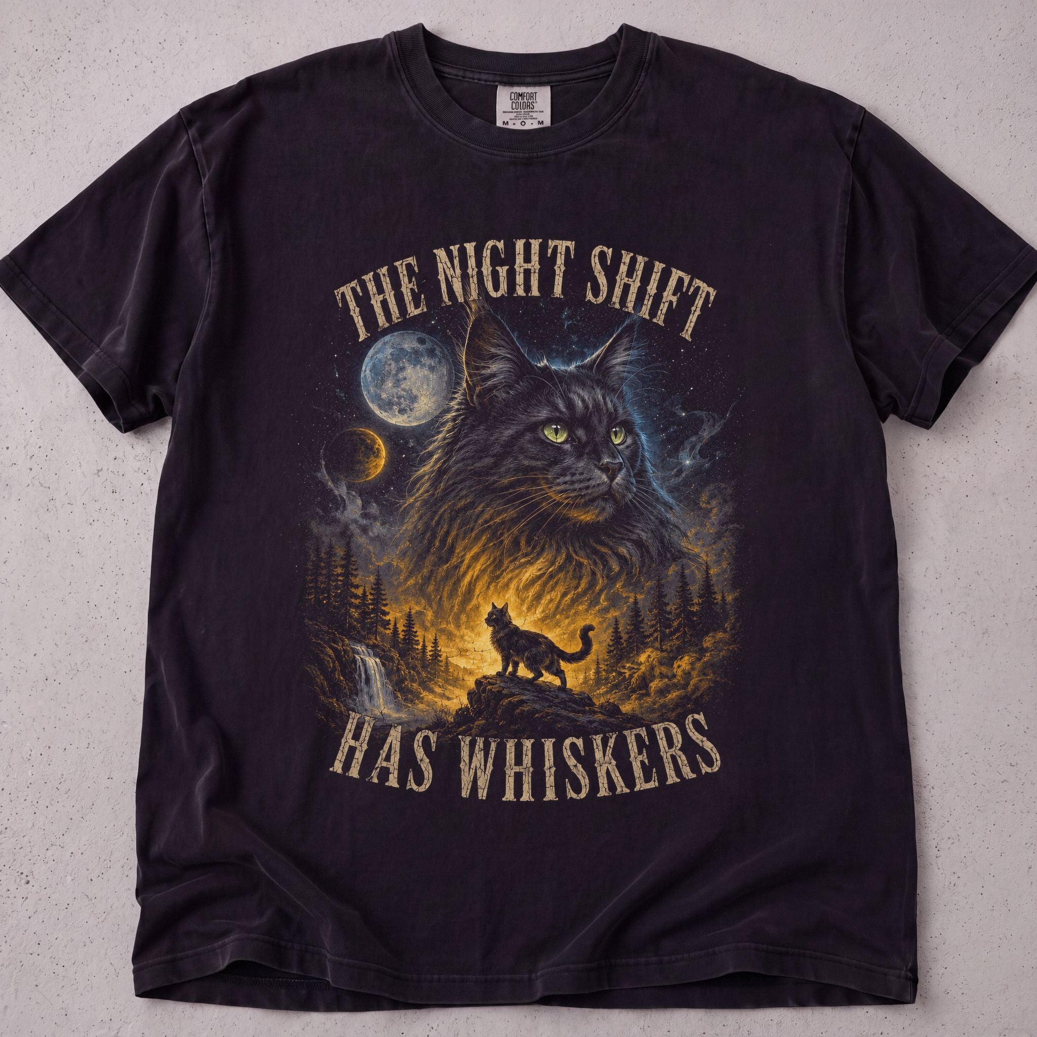 Black cat t-shirt with The Night Shift Has Whiskers printed graphic, funny cat lover tee on soft Comfort Colors cotton, flat lay front view
