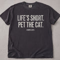 Pepper brown cat t-shirt with Life's Short Pet The Cat printed text graphic, cat lover tee on soft Comfort Colors cotton, flat lay front view
