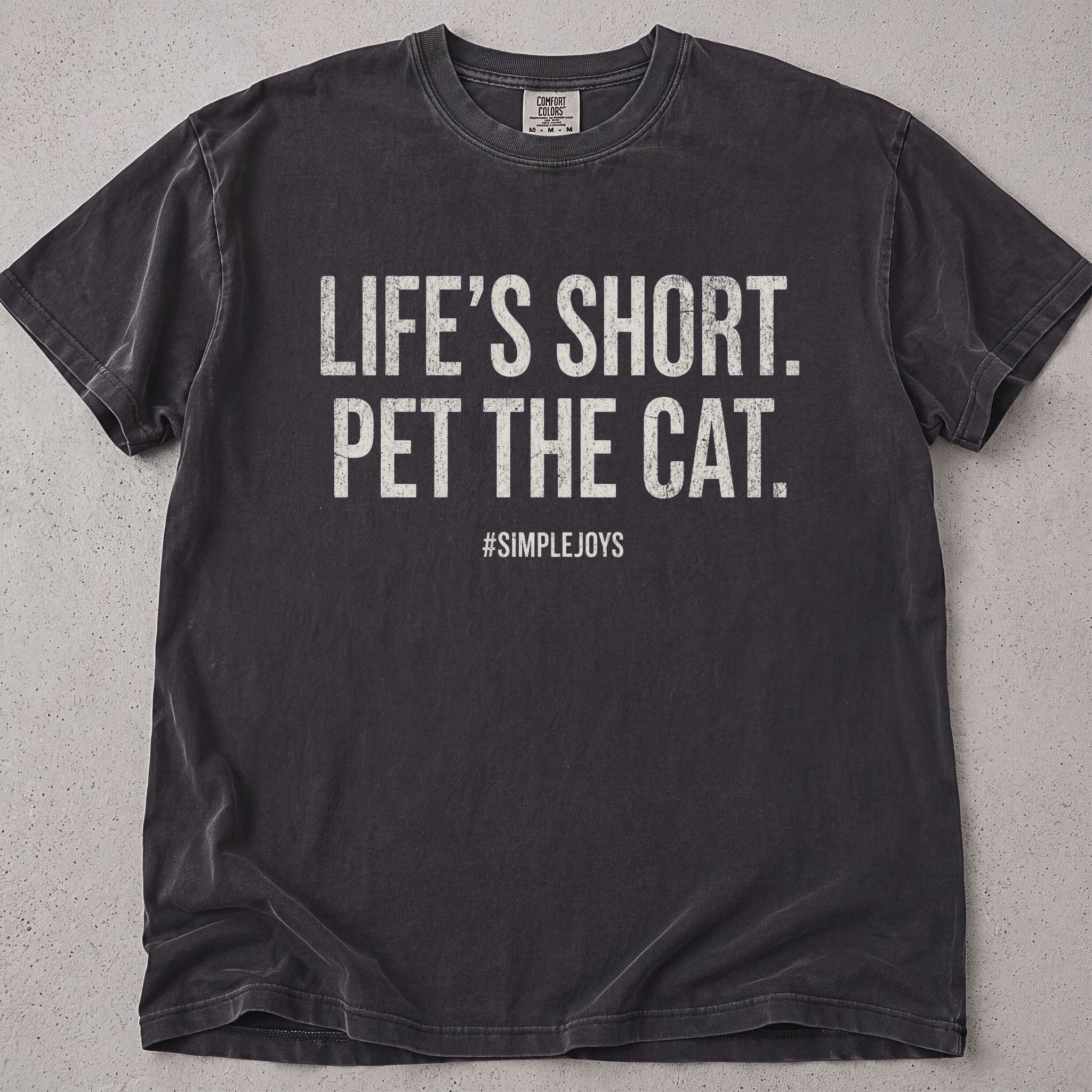 Pepper brown cat t-shirt with Life's Short Pet The Cat printed text graphic, cat lover tee on soft Comfort Colors cotton, flat lay front view
