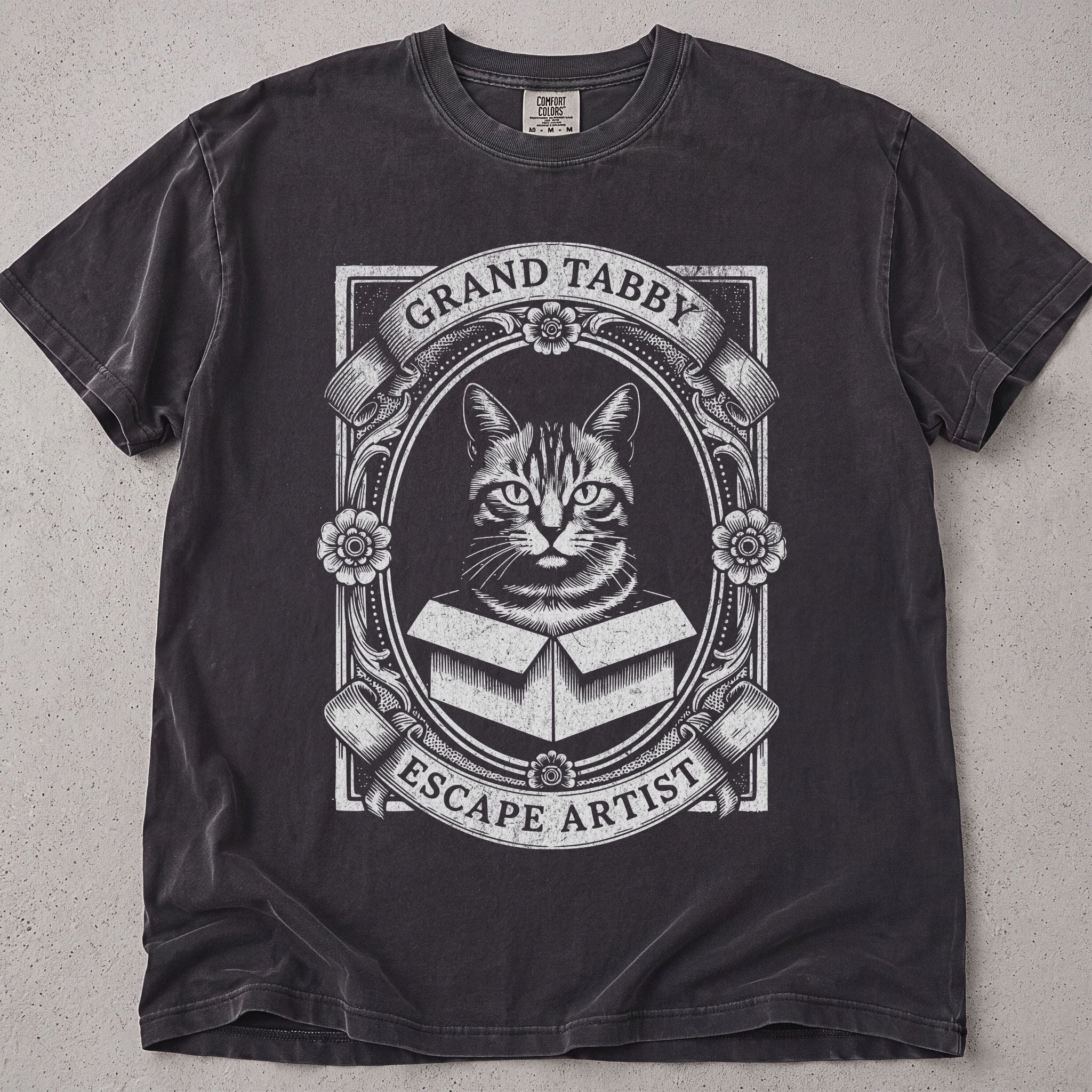 Pepper brown cat t-shirt with an ornate vintage Grand Tabby Escape Artist cat illustration, cat lover tee on soft Comfort Colors cotton, flat lay front view