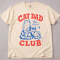Ivory cat t-shirt with a retro red and blue Cat Dad Club cats illustration, cat lover tee on soft Comfort Colors cotton, flat lay front view