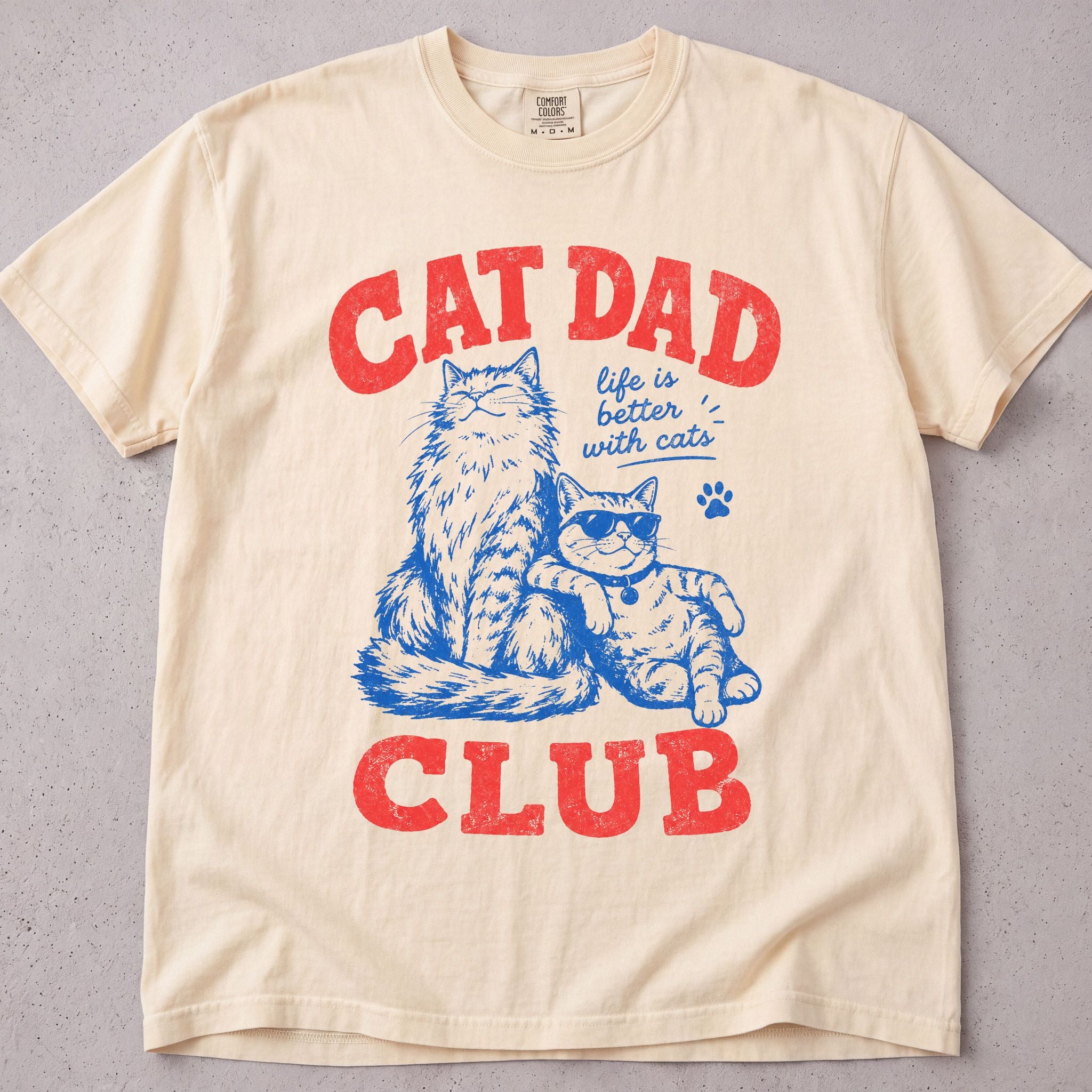 Ivory cat t-shirt with a retro red and blue Cat Dad Club cats illustration, cat lover tee on soft Comfort Colors cotton, flat lay front view