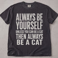 Pepper brown cat t-shirt with Always Be Yourself Unless You Can Be A Cat printed text graphic, funny cat lover tee on soft Comfort Colors cotton, flat lay front view