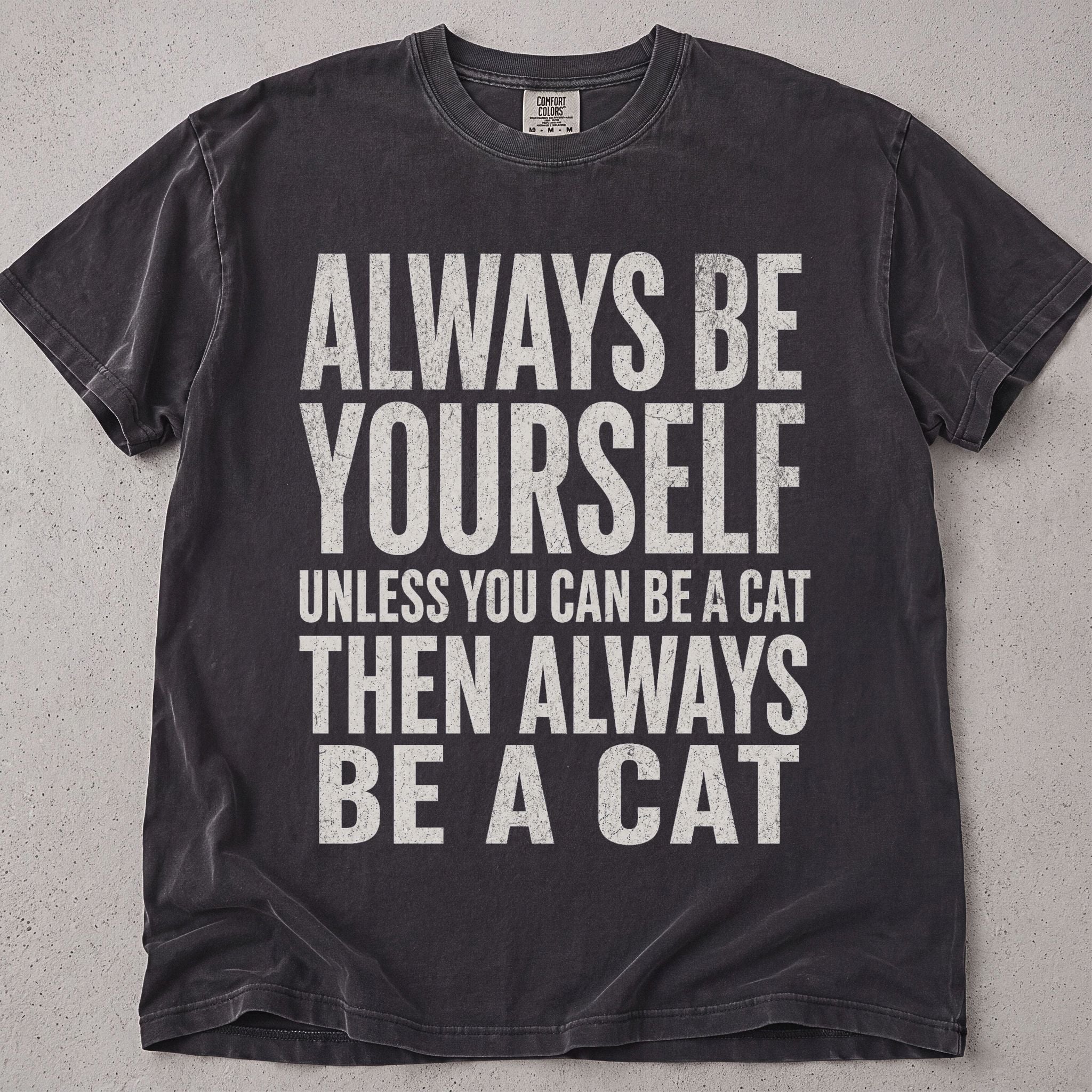 Pepper brown cat t-shirt with Always Be Yourself Unless You Can Be A Cat printed text graphic, funny cat lover tee on soft Comfort Colors cotton, flat lay front view