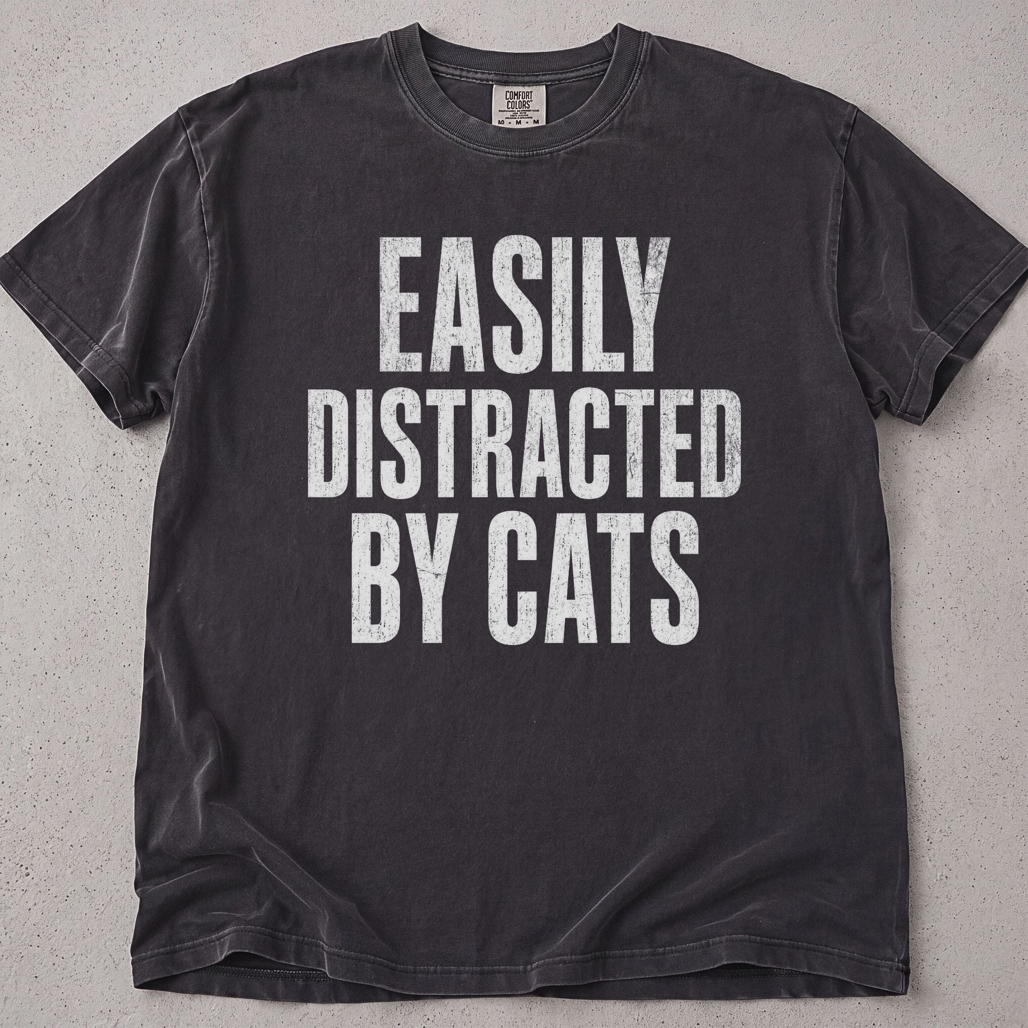 Pepper brown cat t-shirt with Easily Distracted By Cats printed text graphic, funny cat lover tee on soft Comfort Colors cotton, flat lay front view
