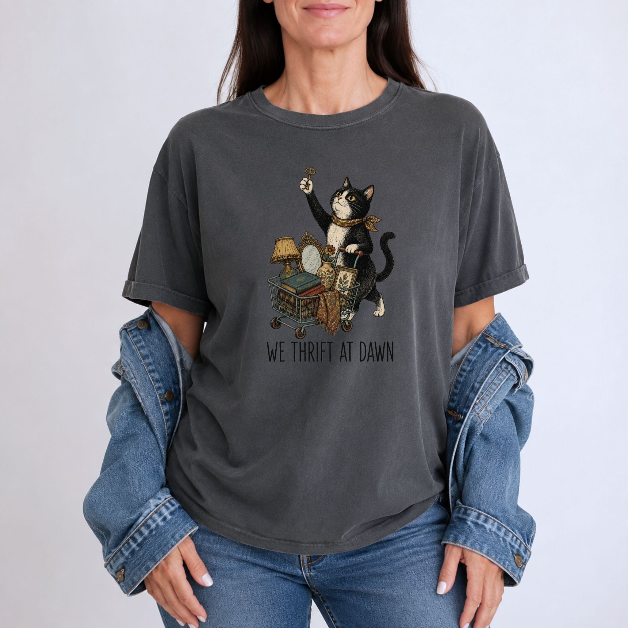 Woman wearing a Pepper We Thrift At Dawn t-shirt with a vintage tuxedo cat thrift graphic