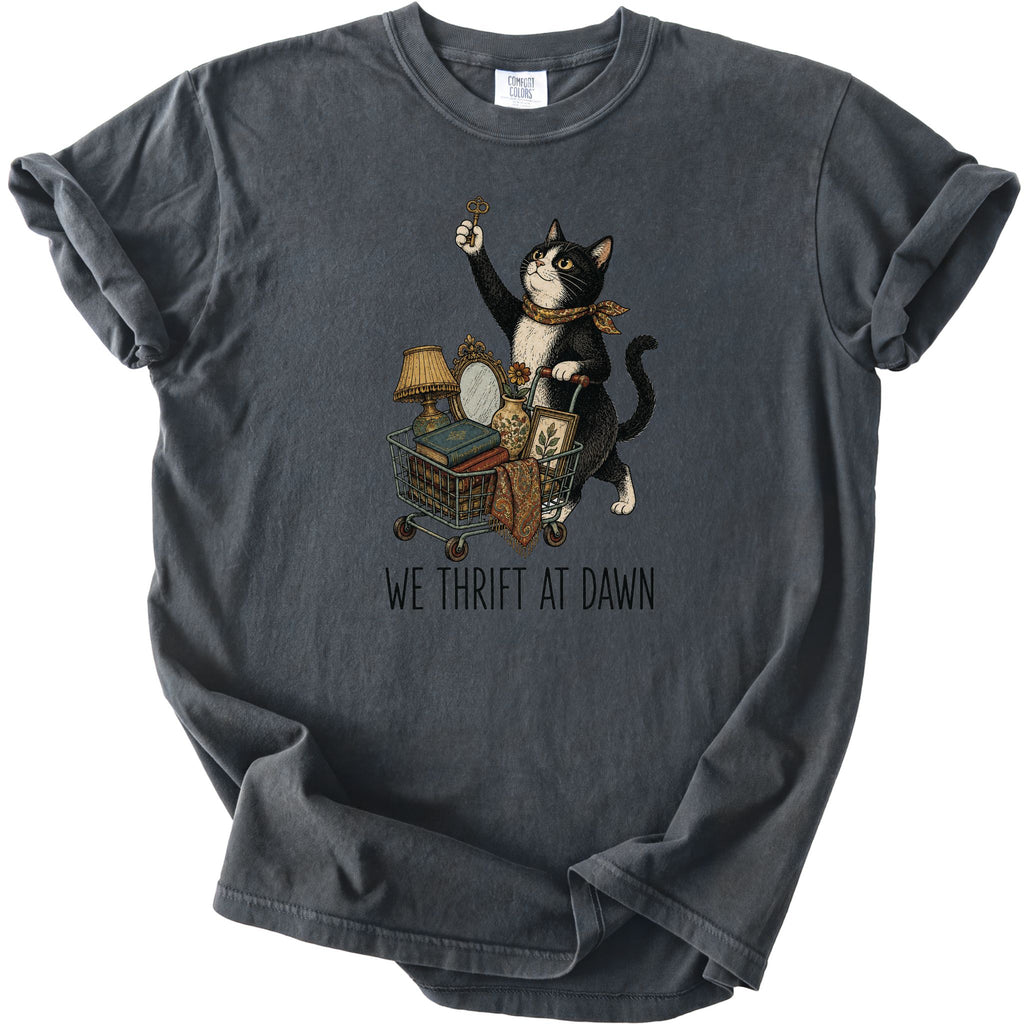 Pepper We Thrift At Dawn t-shirt with a tuxedo cat and thrift cart graphic, front flat lay