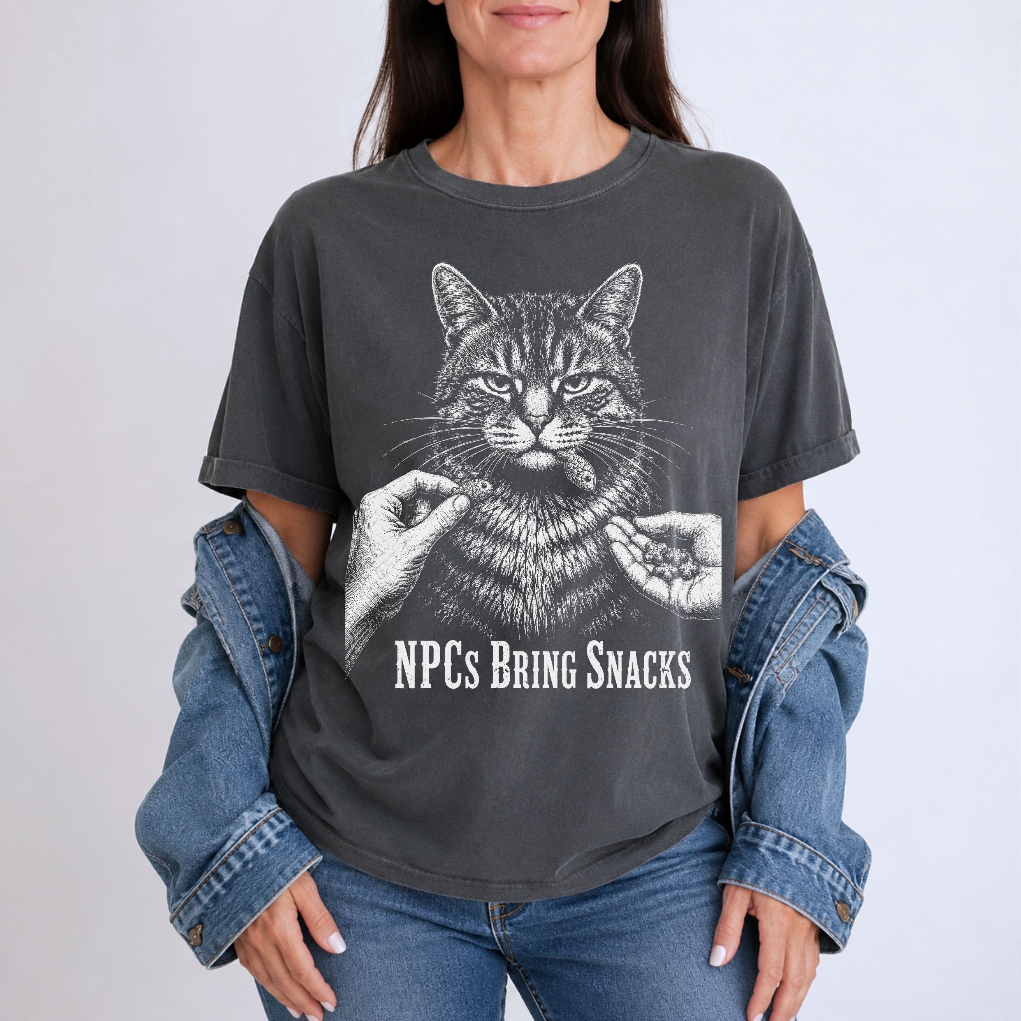 Woman wearing a Pepper NPCs Bring Snacks t-shirt with a tabby cat and treat graphic
