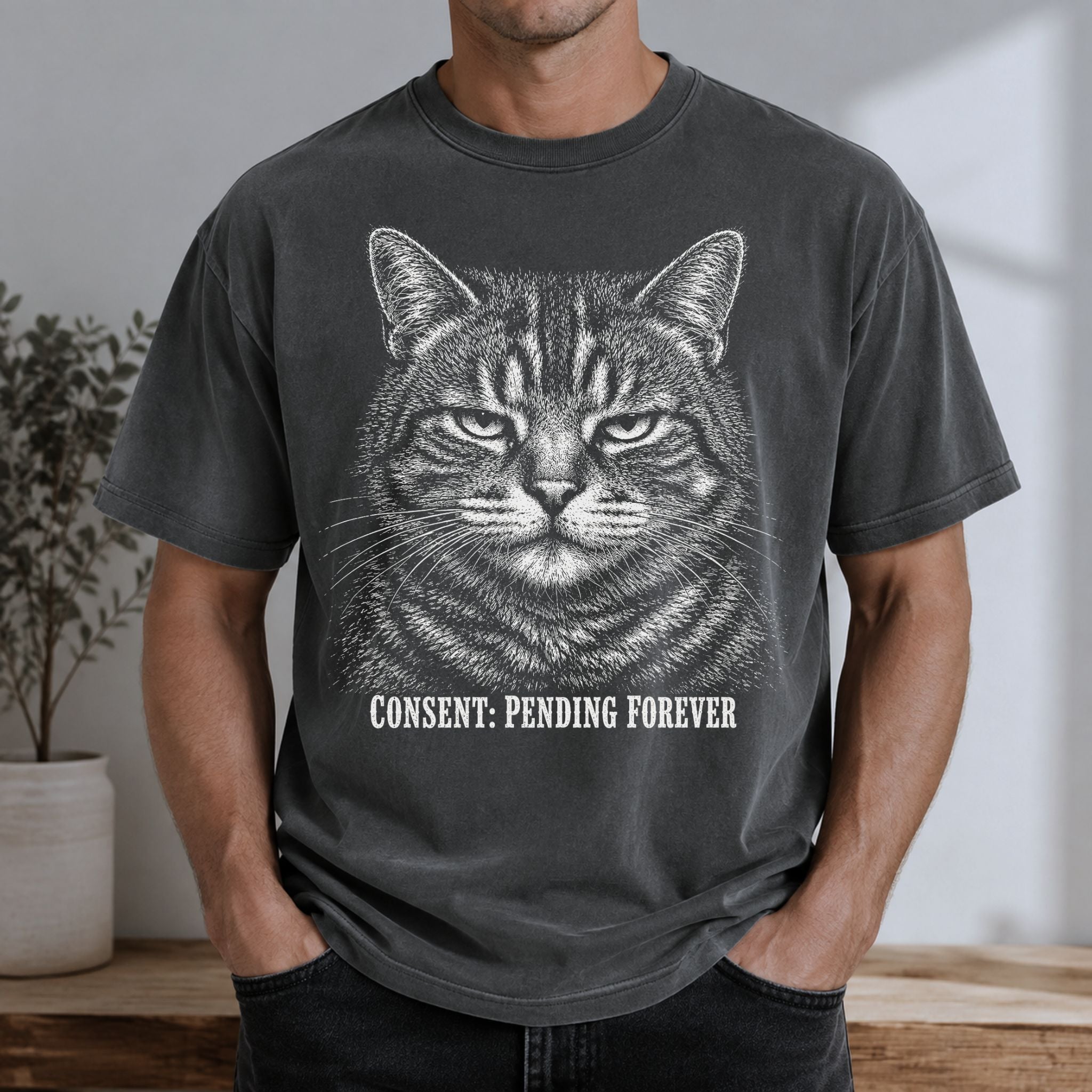 Man wearing a Pepper Pending Forever t-shirt with a large tabby cat graphic