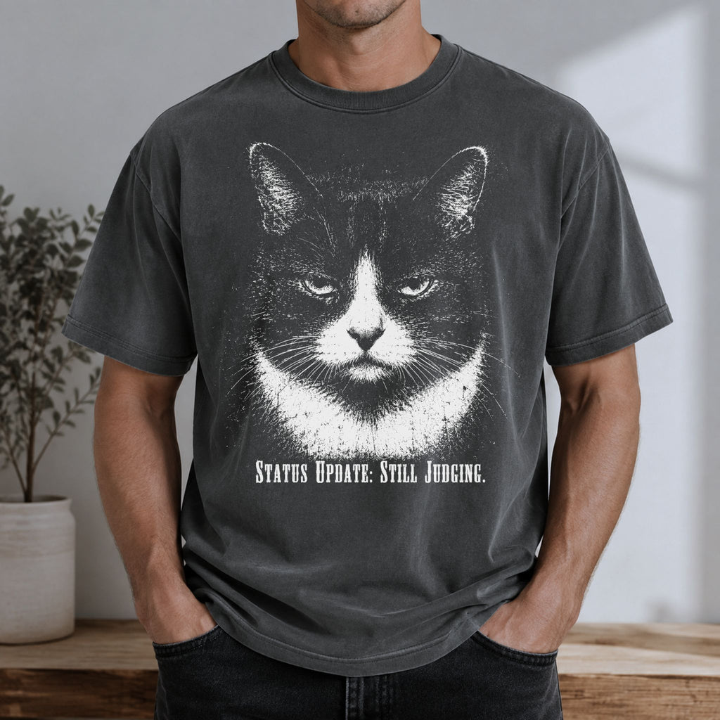 Man wearing a Pepper Still Judging t-shirt with a large tuxedo cat graphic
