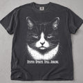 Pepper Still Judging cat t-shirt with black and white tuxedo cat graphic, front flat lay