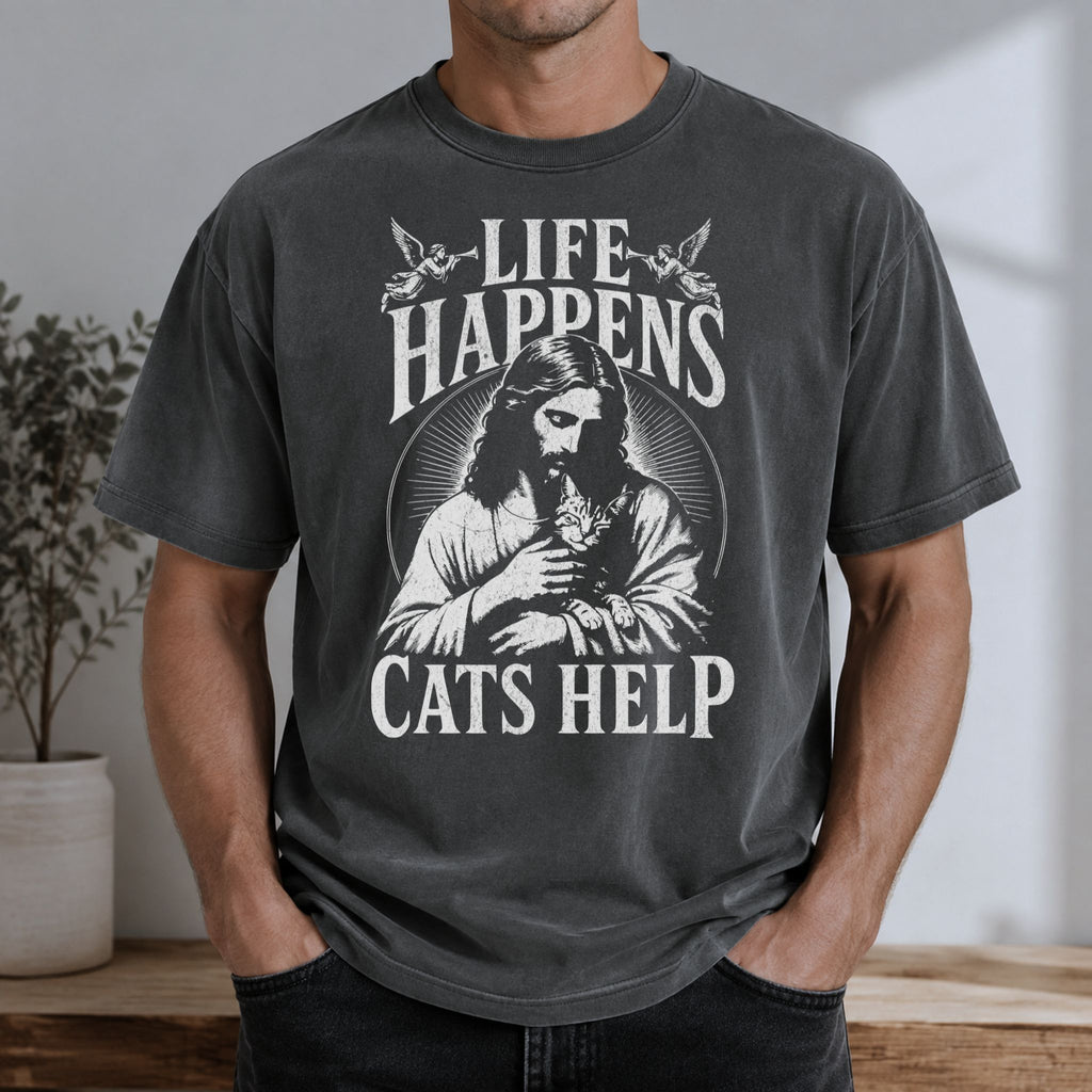 Man wearing a Pepper Jesus and cat graphic t-shirt with Life Happens, Cats Help text