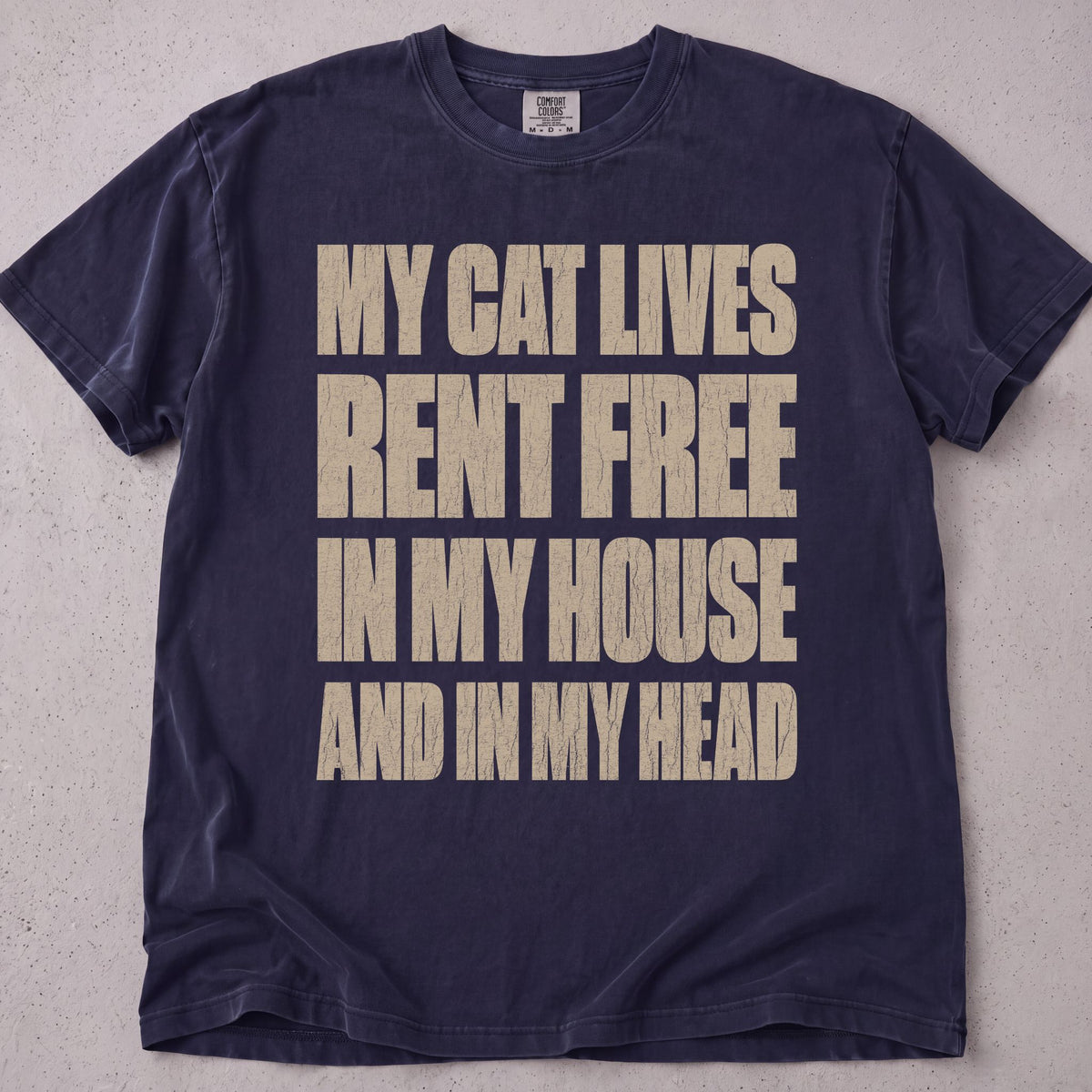 Flat lay of a pepper printed cat lover t-shirt with My Cat Lives Rent Free graphic