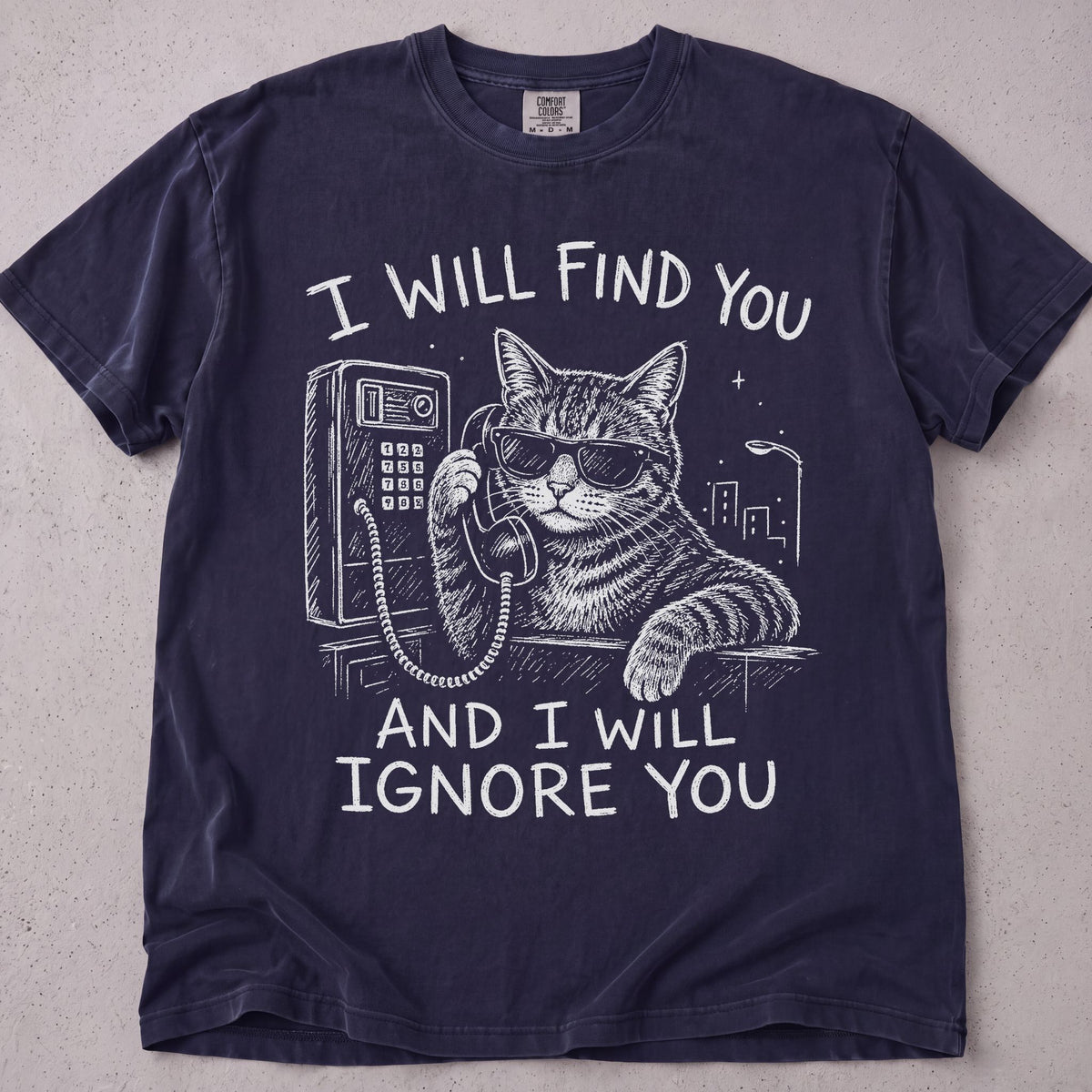 Flat lay of a black printed cat lover t-shirt with I Will Find You graphic