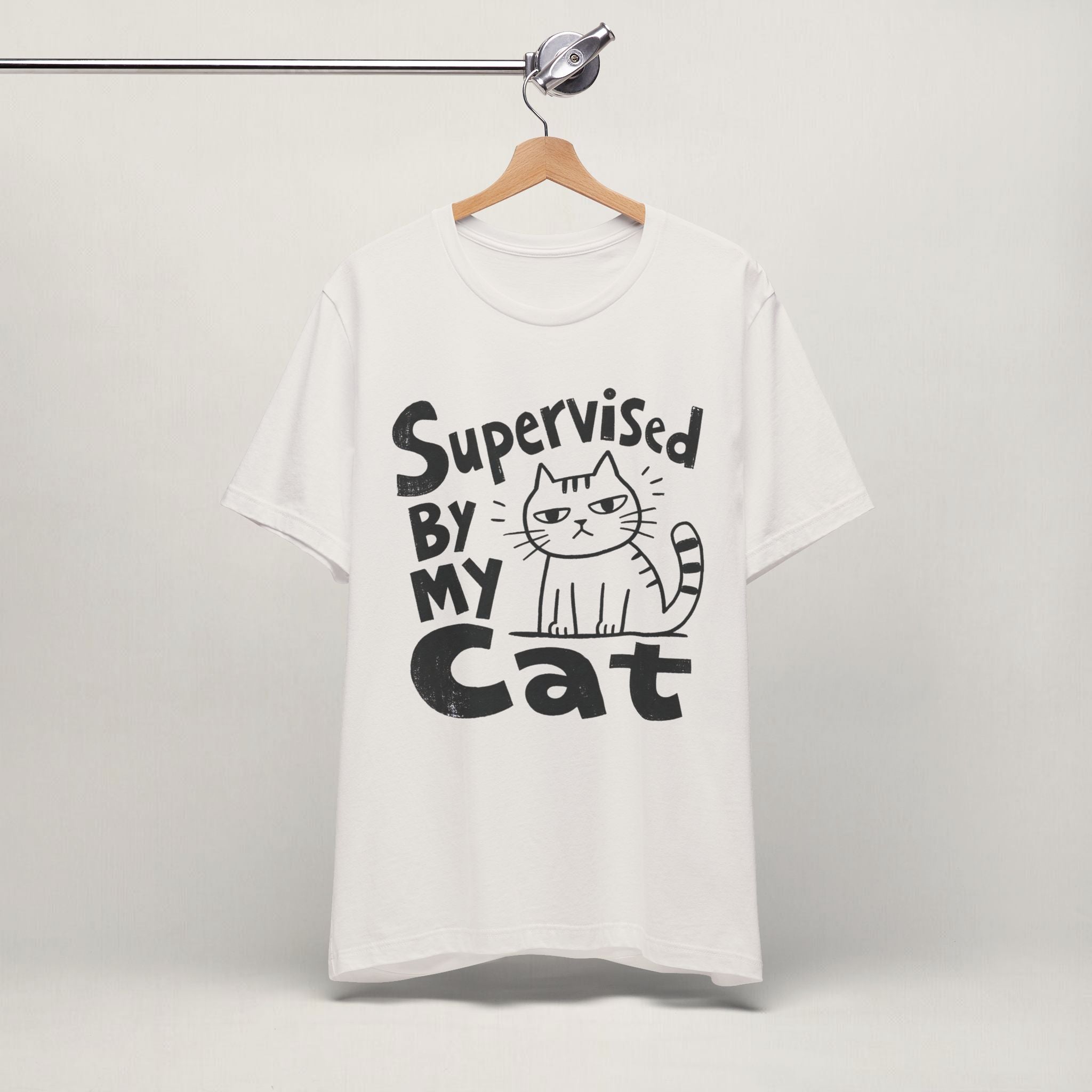 Vintage white Supervised By My Cat t-shirt with striped cat graphic hanging on display