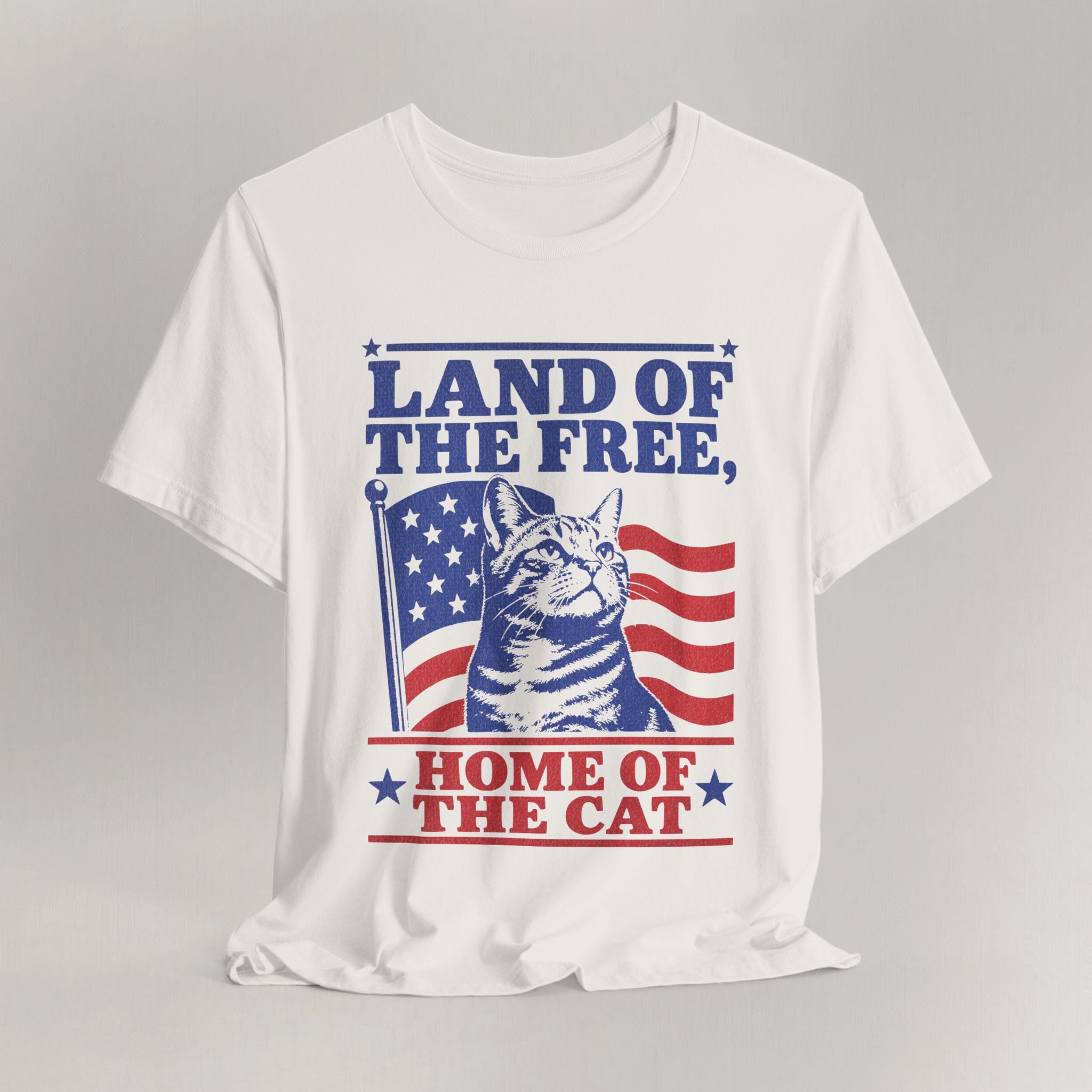 Flat lay of vintage white graphic cat t-shirt with Land of the Free patriotic cat design