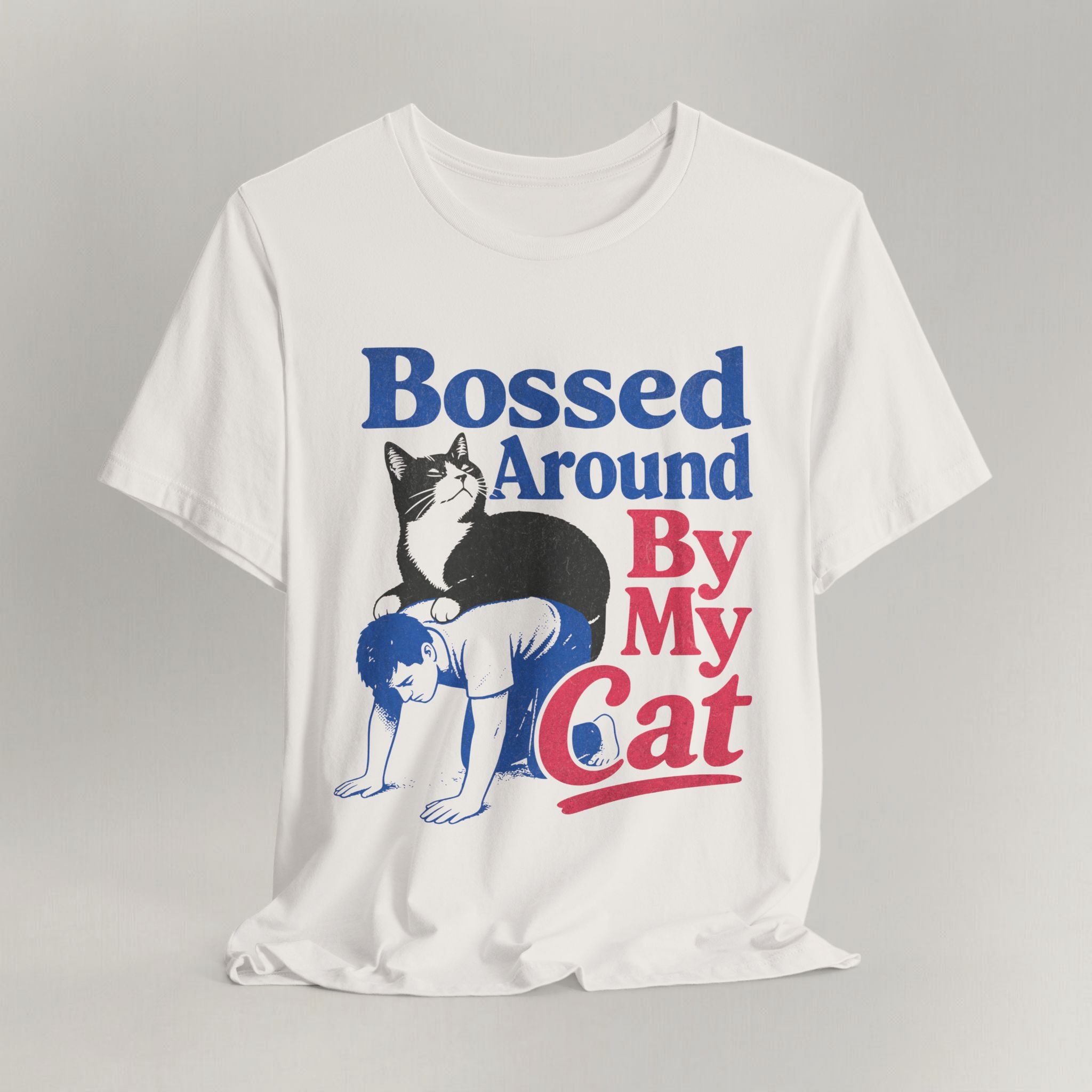 Flat lay of vintage white retro graphic cat t-shirt with bold Bossed Around By My Cat print design