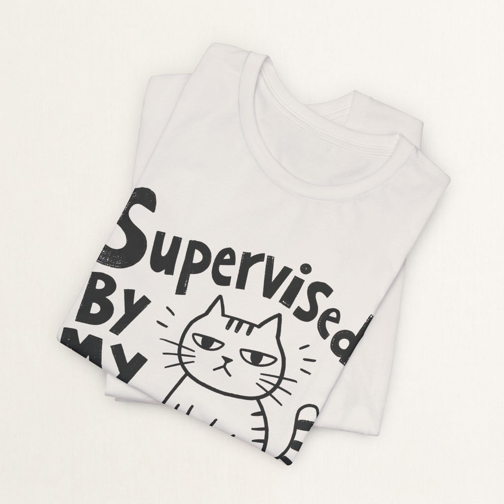 Folded vintage white Supervised By My Cat t-shirt with hand-drawn striped cat graphic