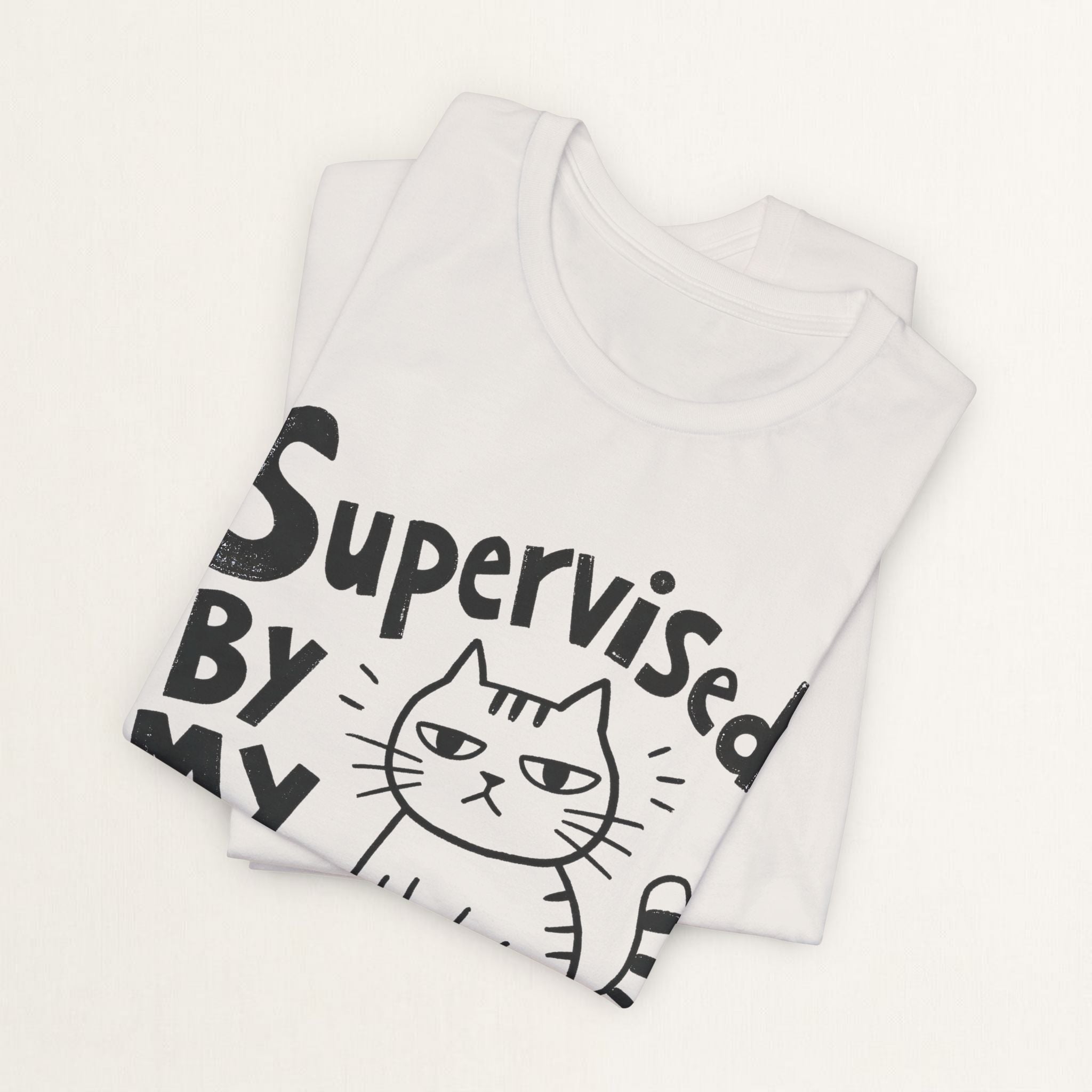 Folded vintage white Supervised By My Cat t-shirt with hand-drawn striped cat graphic