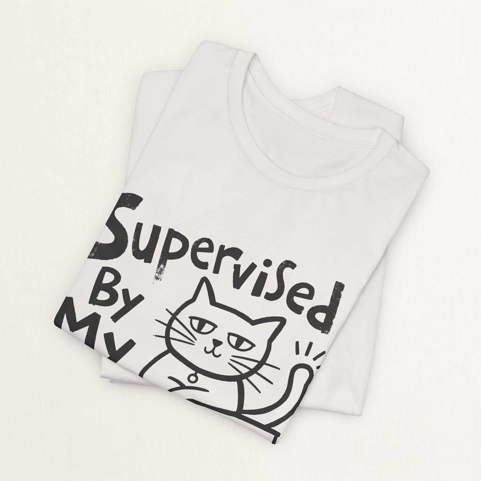 Folded vintage white Supervised By My Cat t-shirt with hand-drawn sketch graphic