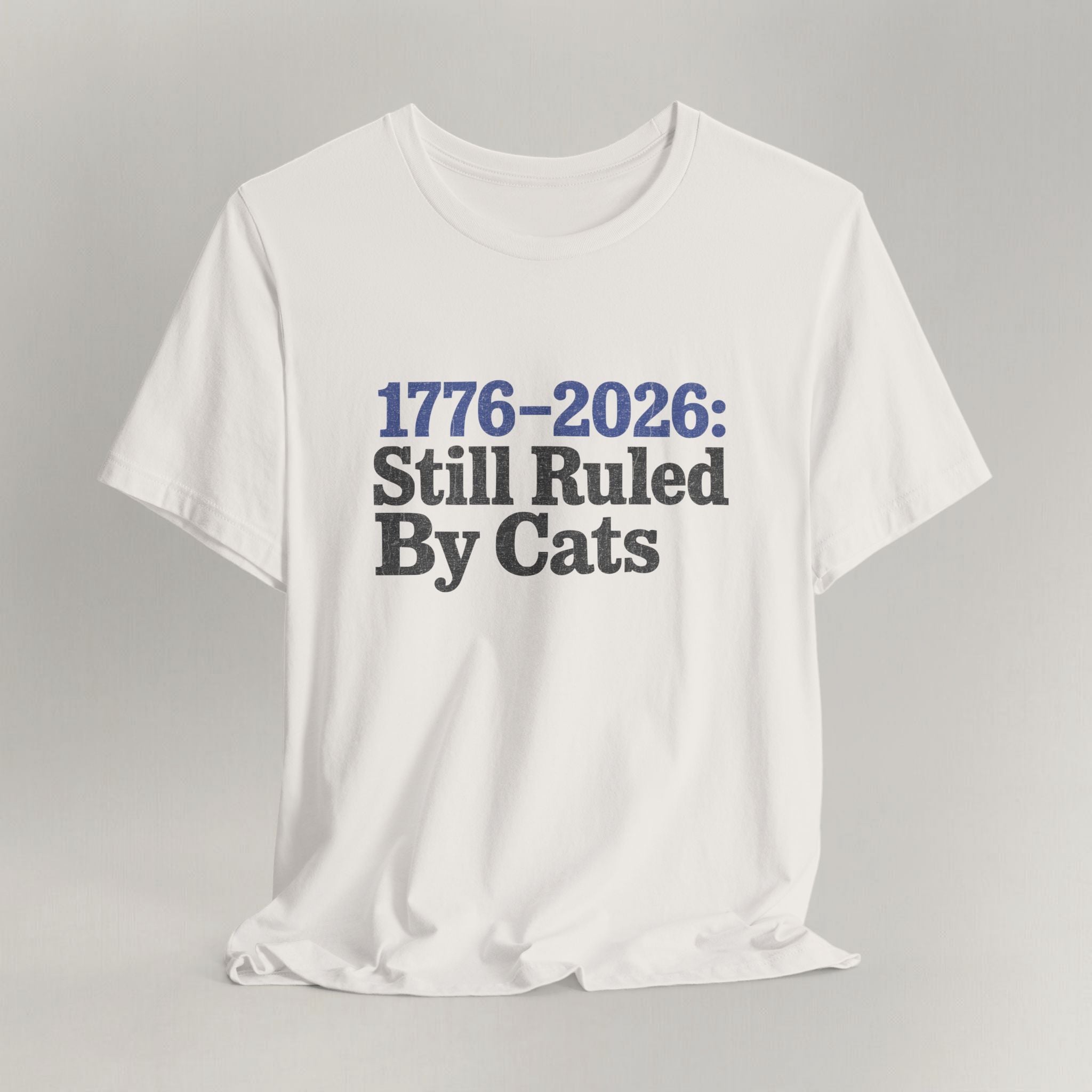 Styled flat lay of vintage black Ruled By Cats cat graphic tee