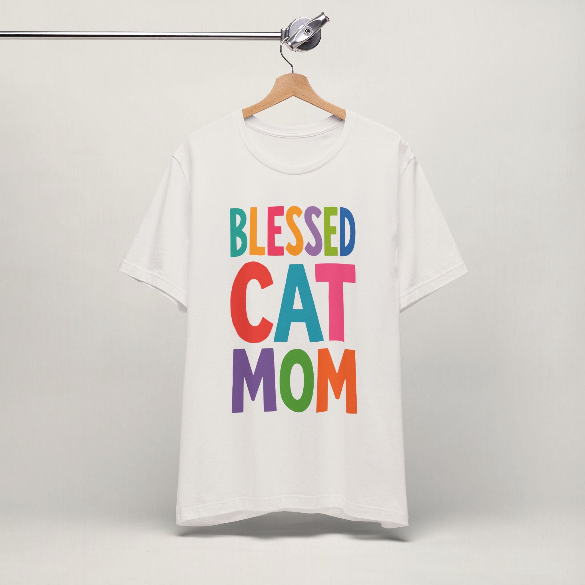 Vintage white Blessed Cat Mom cat t-shirt on a hanger