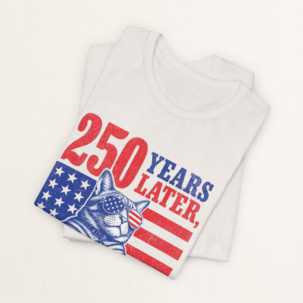 Styled flat lay of vintage white Still In Charge cat graphic tee