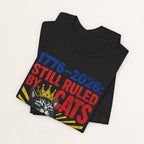 Close-up of Still Ruled By Cats print on black unisex t-shirt