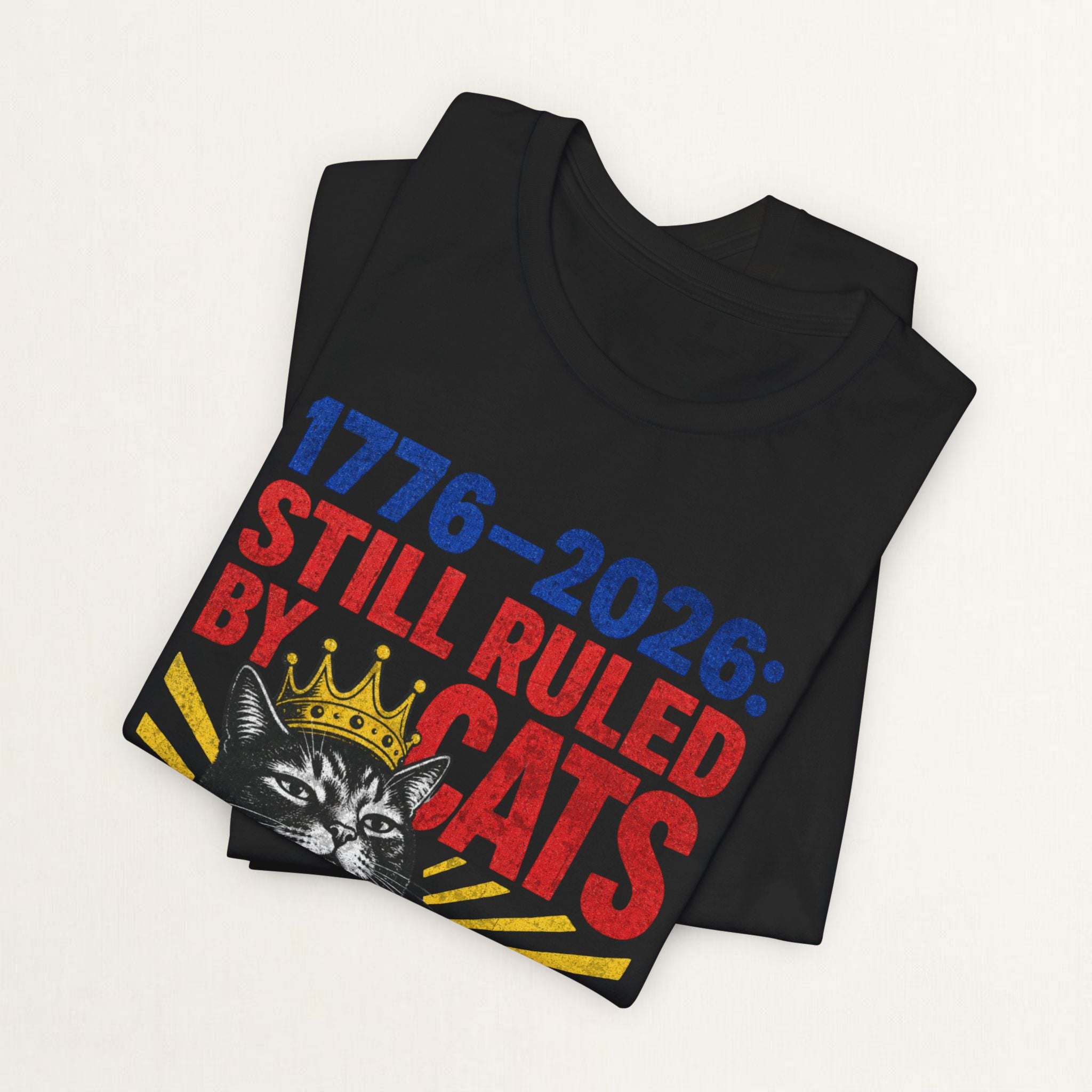 Close-up of Still Ruled By Cats print on black unisex t-shirt