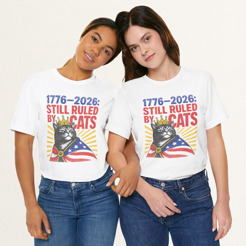 Styled flat lay of white Still Ruled By Cats cat graphic tee