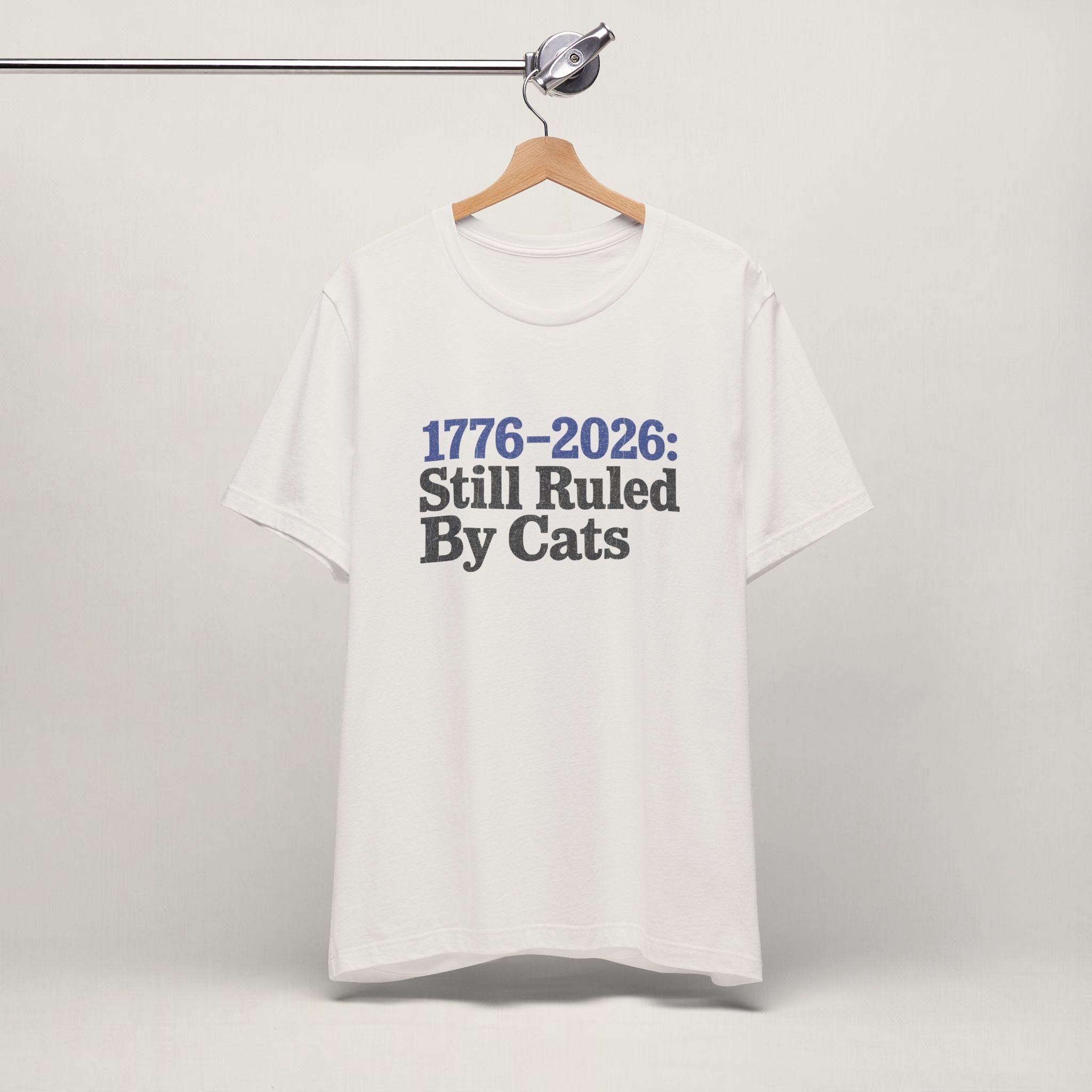 Close-up of Ruled By Cats print on vintage white unisex t-shirt