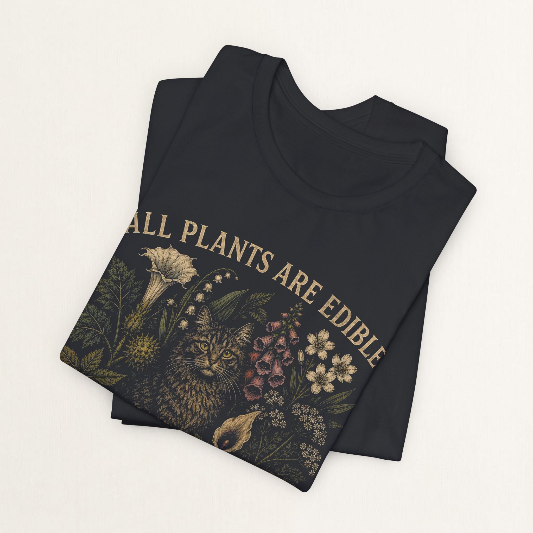 Folded vintage black All Plants Are Edible cottagecore cat t-shirt