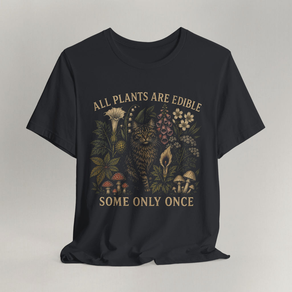 Vintage black cat t-shirt with an All Plants Are Edible cottagecore botanical design and a cat, shown flat
