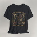 Vintage black cat t-shirt with an All Plants Are Edible cottagecore botanical design and a cat, shown flat