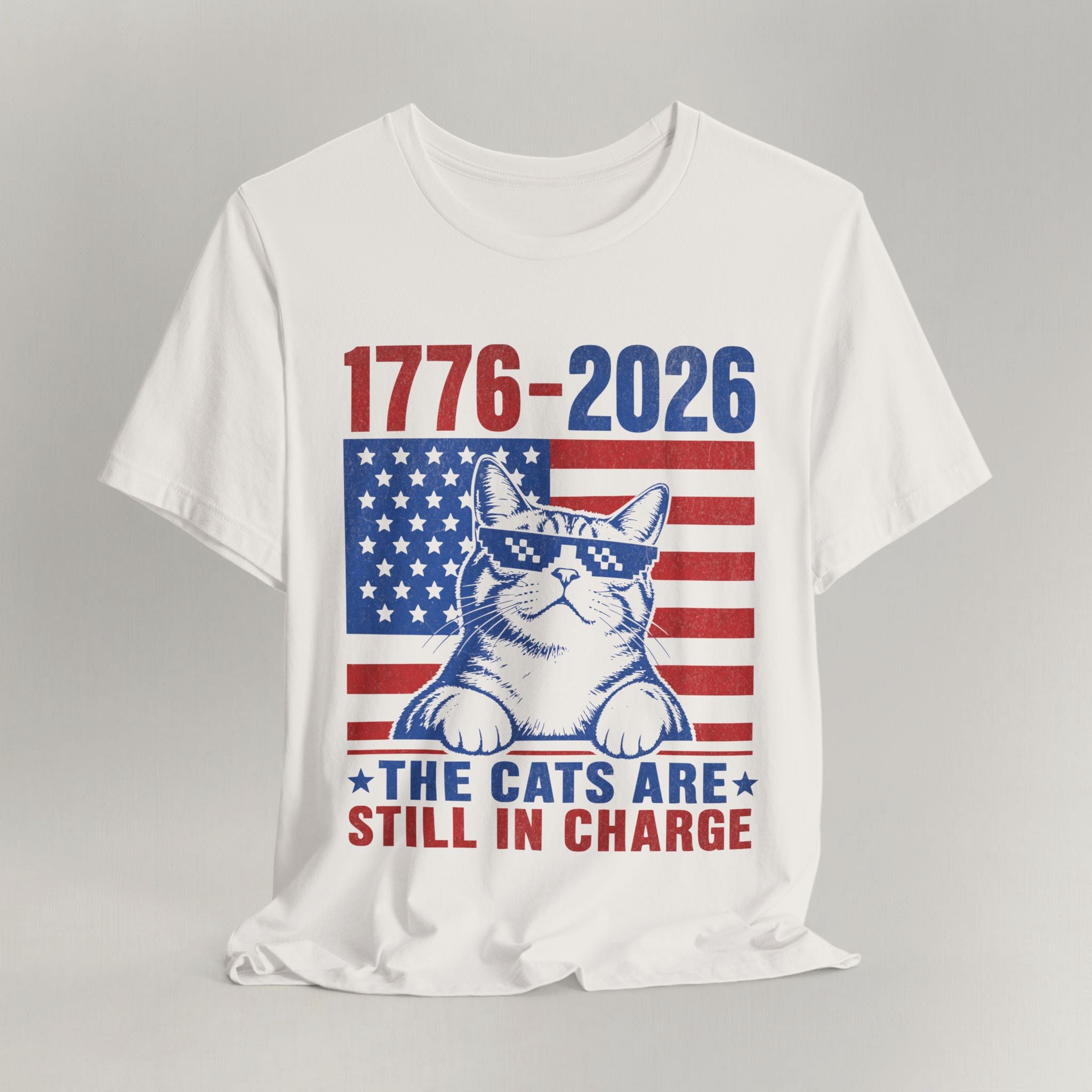 Flat lay of vintage white graphic cat t-shirt with The Cats Are Still In Charge print design