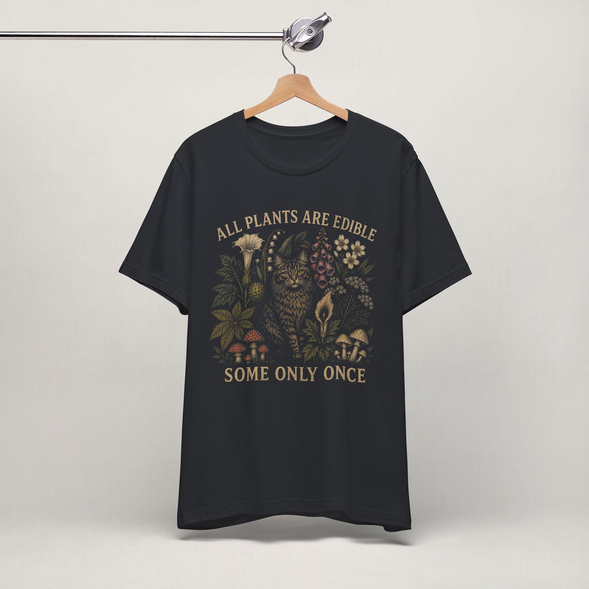 Vintage black All Plants Are Edible cottagecore cat t-shirt on a hanger