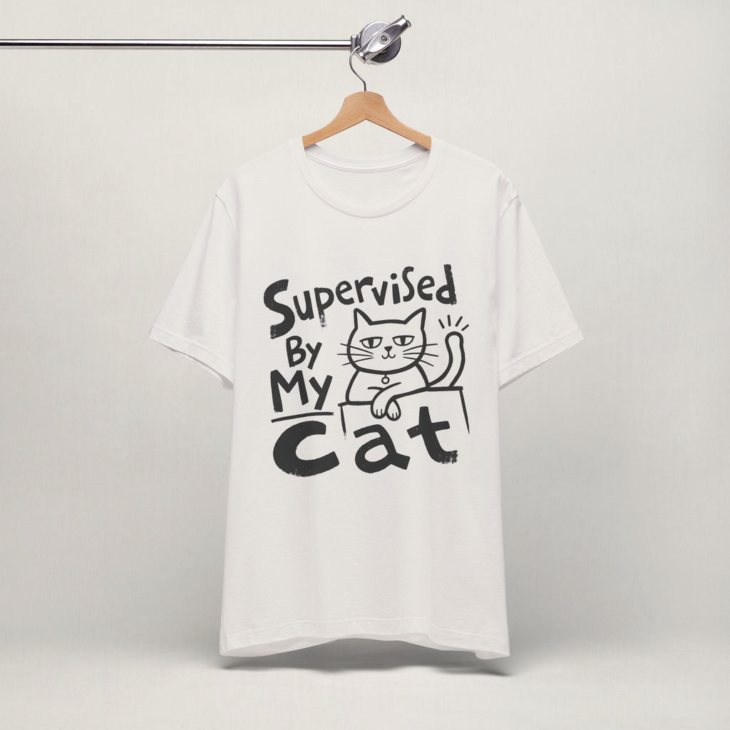 Vintage white Supervised By My Cat t-shirt with hand-drawn graphic hanging on display