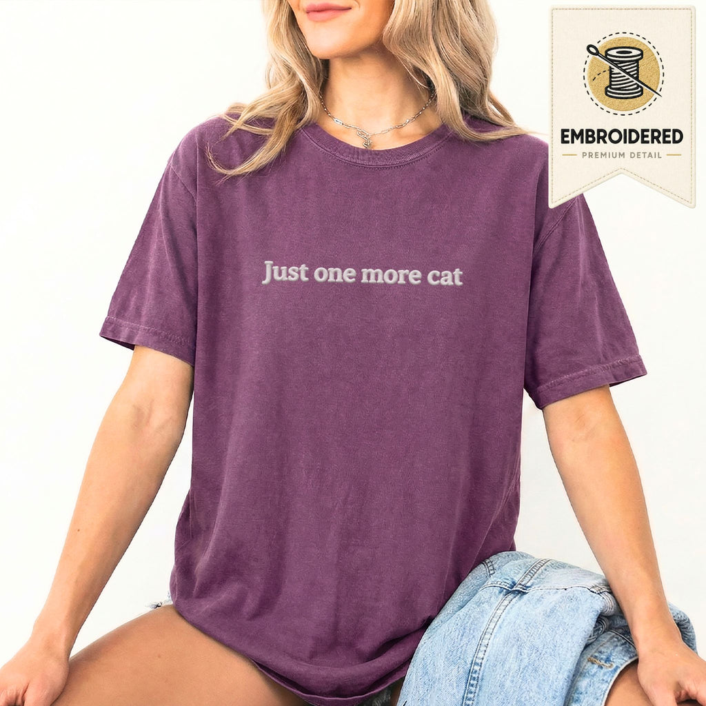 Woman wearing a berry embroidered 'Just One More Cat' t-shirt