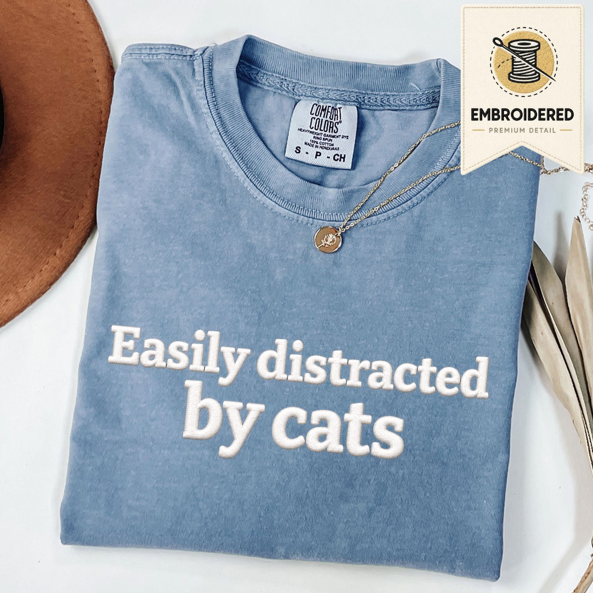 Blue Jean embroidered cat t-shirt with 'Easily Distracted' chest design, shown flat