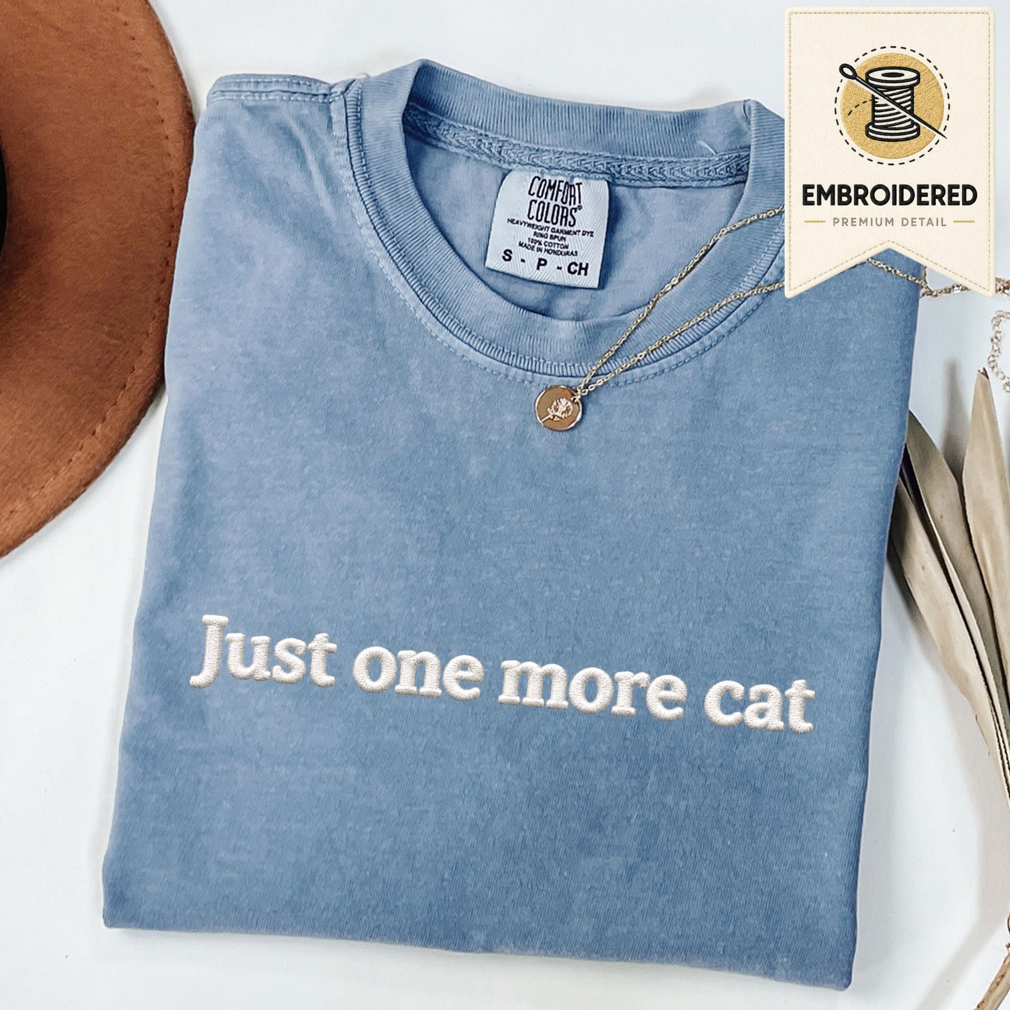Blue Jean embroidered cat t-shirt with 'Just One More Cat' chest design, shown flat