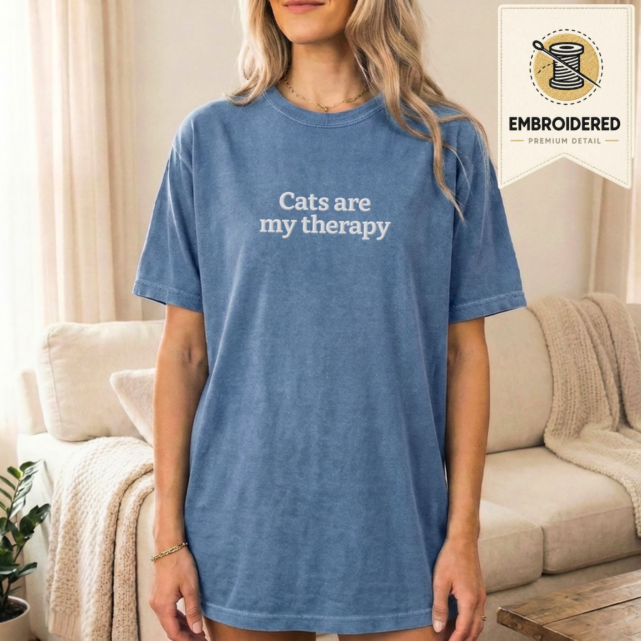 Woman wearing a blue jean embroidered 'Cats Are My Therapy' t-shirt
