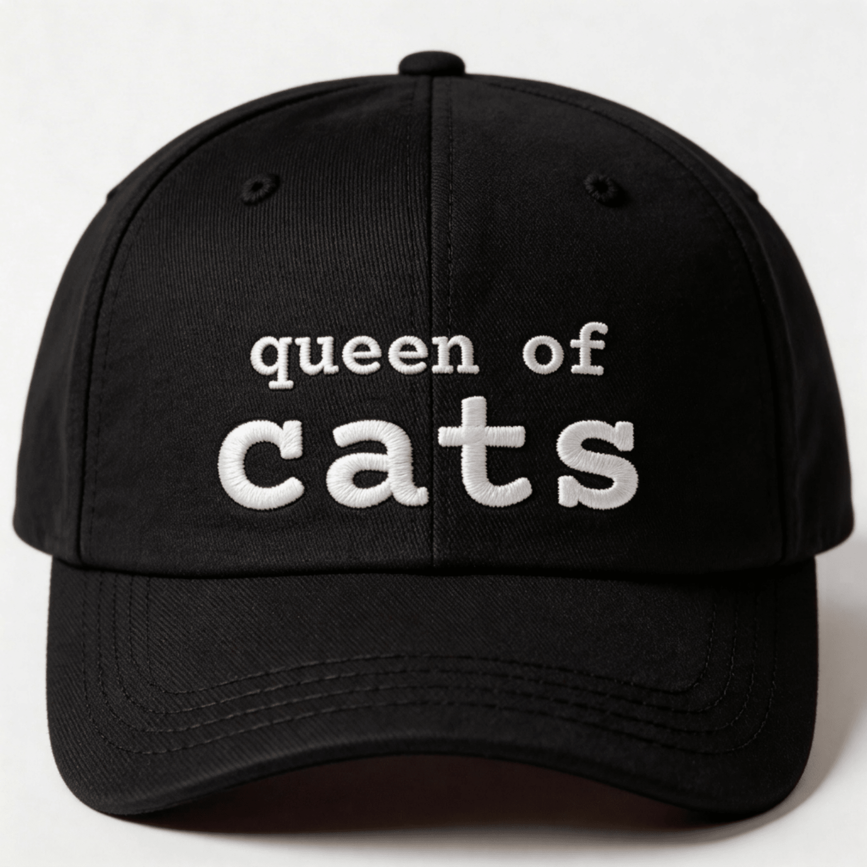 Black embroidered cat cap with the phrase “queen of cats” shown from the front